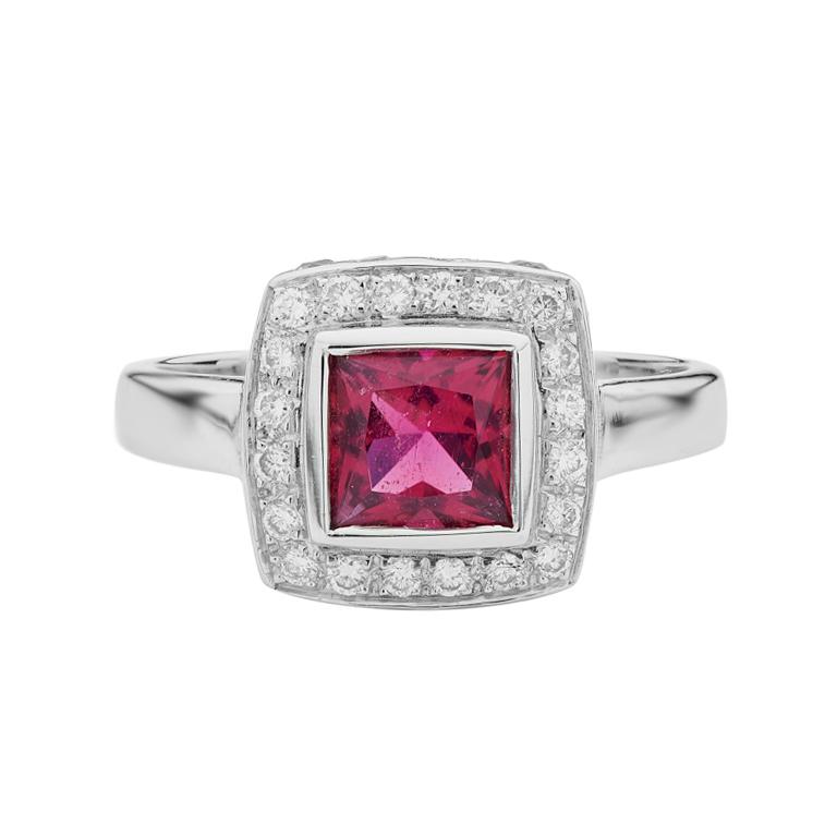 DEAKIN & FRANCIS, Piccadilly Arcade, London

This 18ct white gold rubellite and diamond ring with blue sapphires is certainly something special! Comprising of a central princess cut red rubellite, with diamond border. This ring also features blue