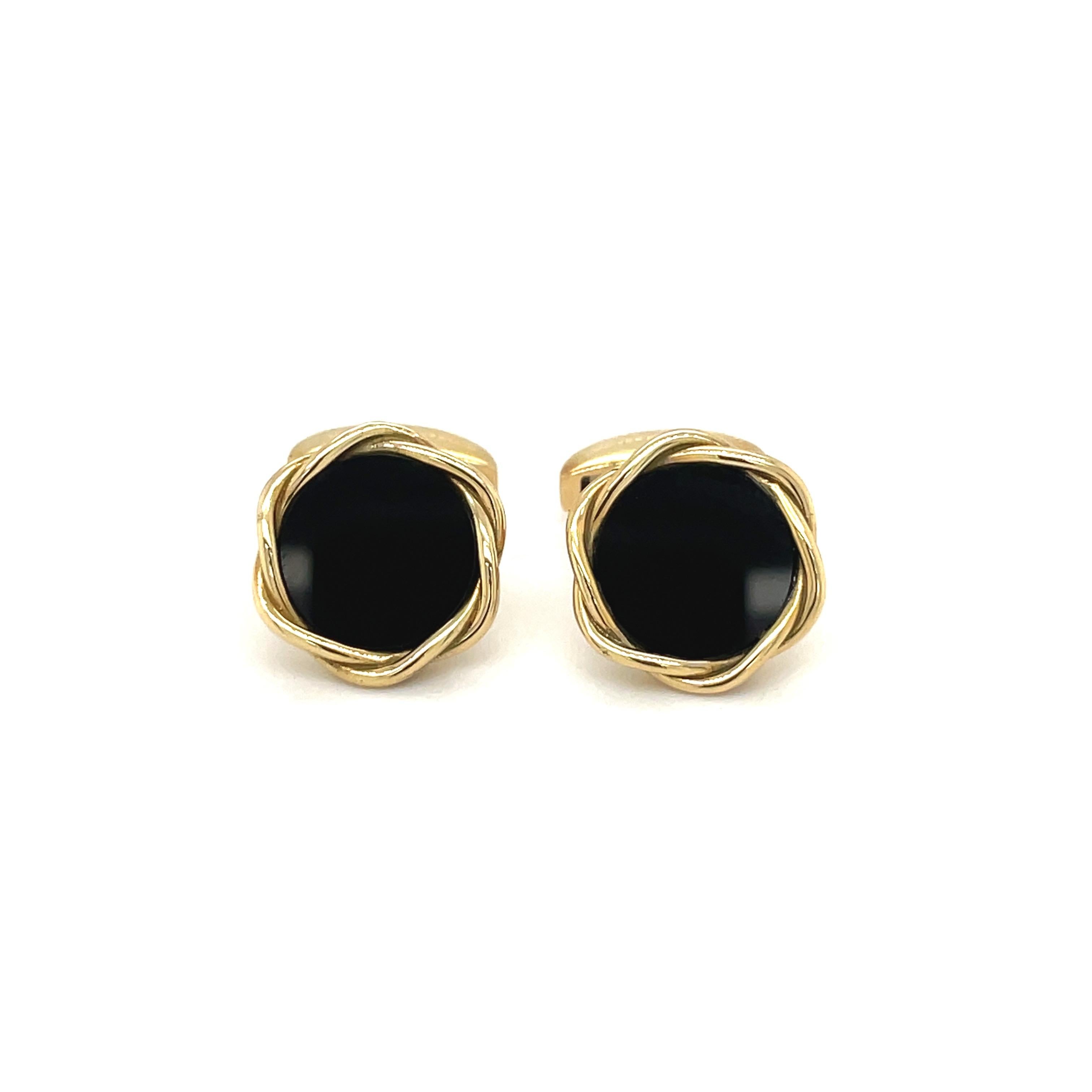 18 karat yellow gold round cuff links by Deakin & Francis, England's oldest family jewelers since 1786.
The round cuff links center black onyx with a gold twisted bezel. The bar back style cuff links are 15 mm diameter.
Stamped  England  D&F  750