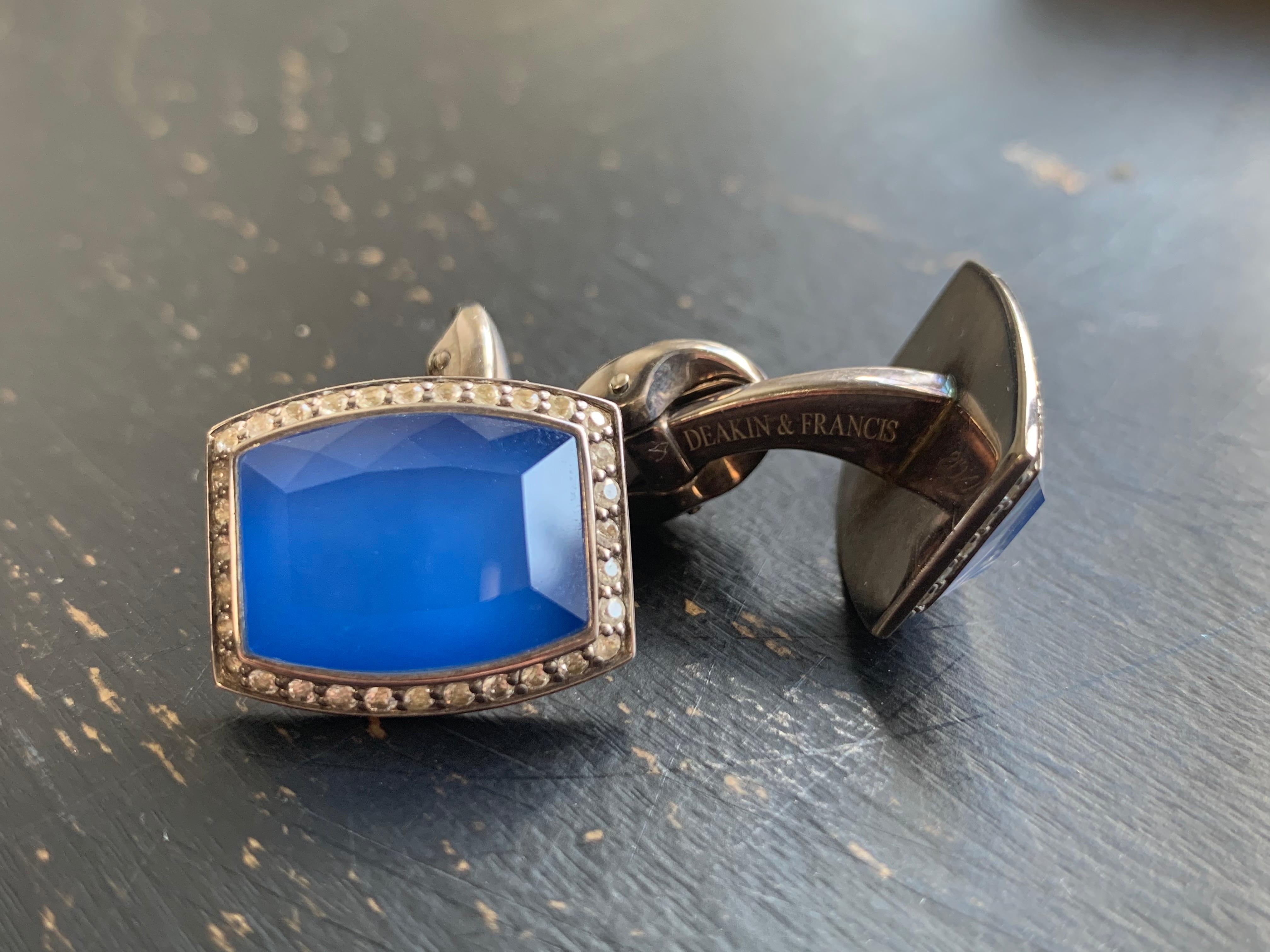 Beautiful, blue Barrel Shaped Cufflinks in Sterling Silver are edged in White Sapphire pave surrounding a doublet of Crystal Quartz and synthetic blue chalcedony.
England's oldest and most respected cufflink company was founded in 1786 and is in its