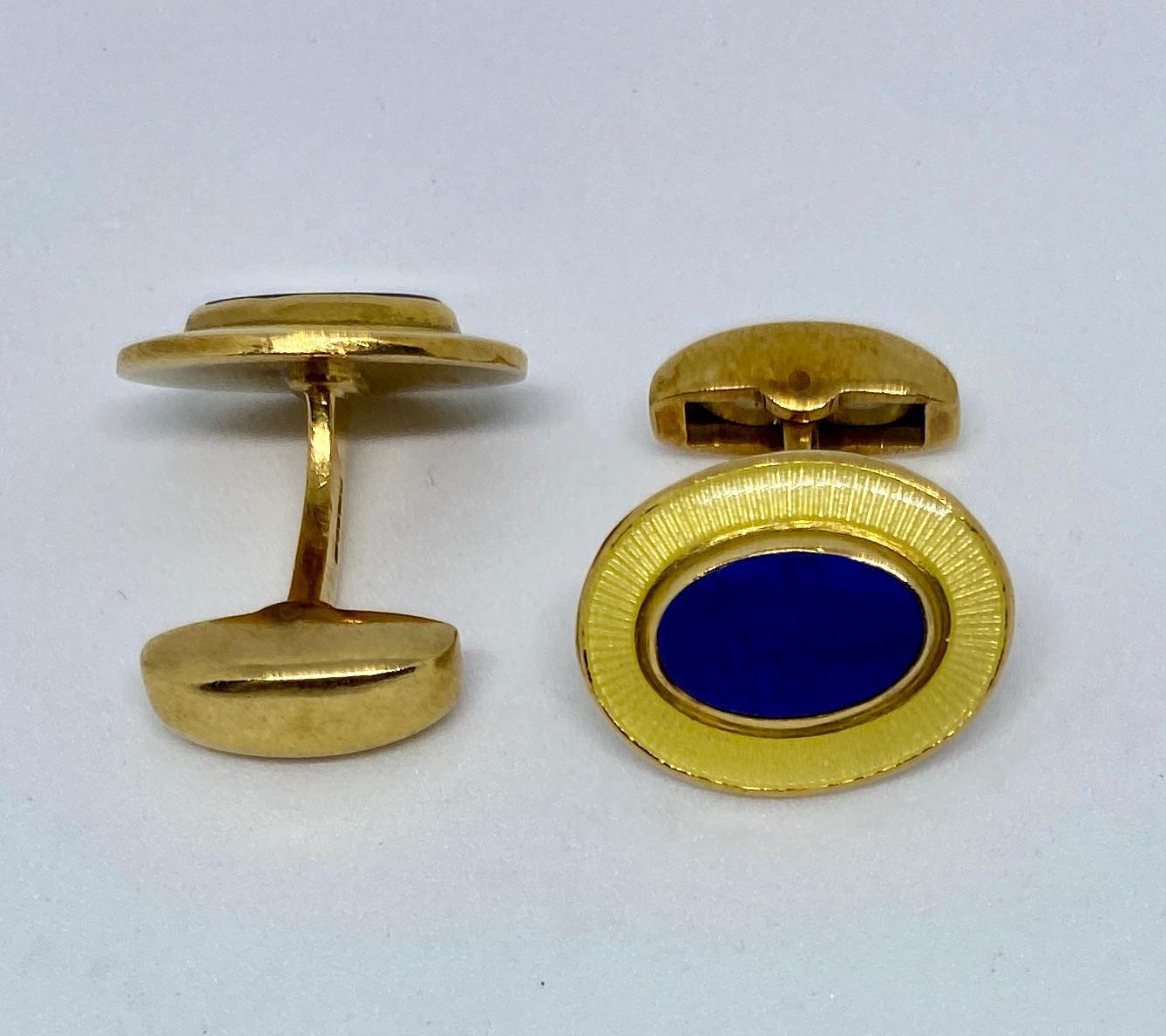 Fantastic, oval-shaped cufflinks featuring hand-cut lapis inlays and clear enamel over an engraved border. With hinged backs, these cufflinks are extremely versatile and easy to insert and remove.

The cufflinks feature numerous marks: D&F, ENGLAND,