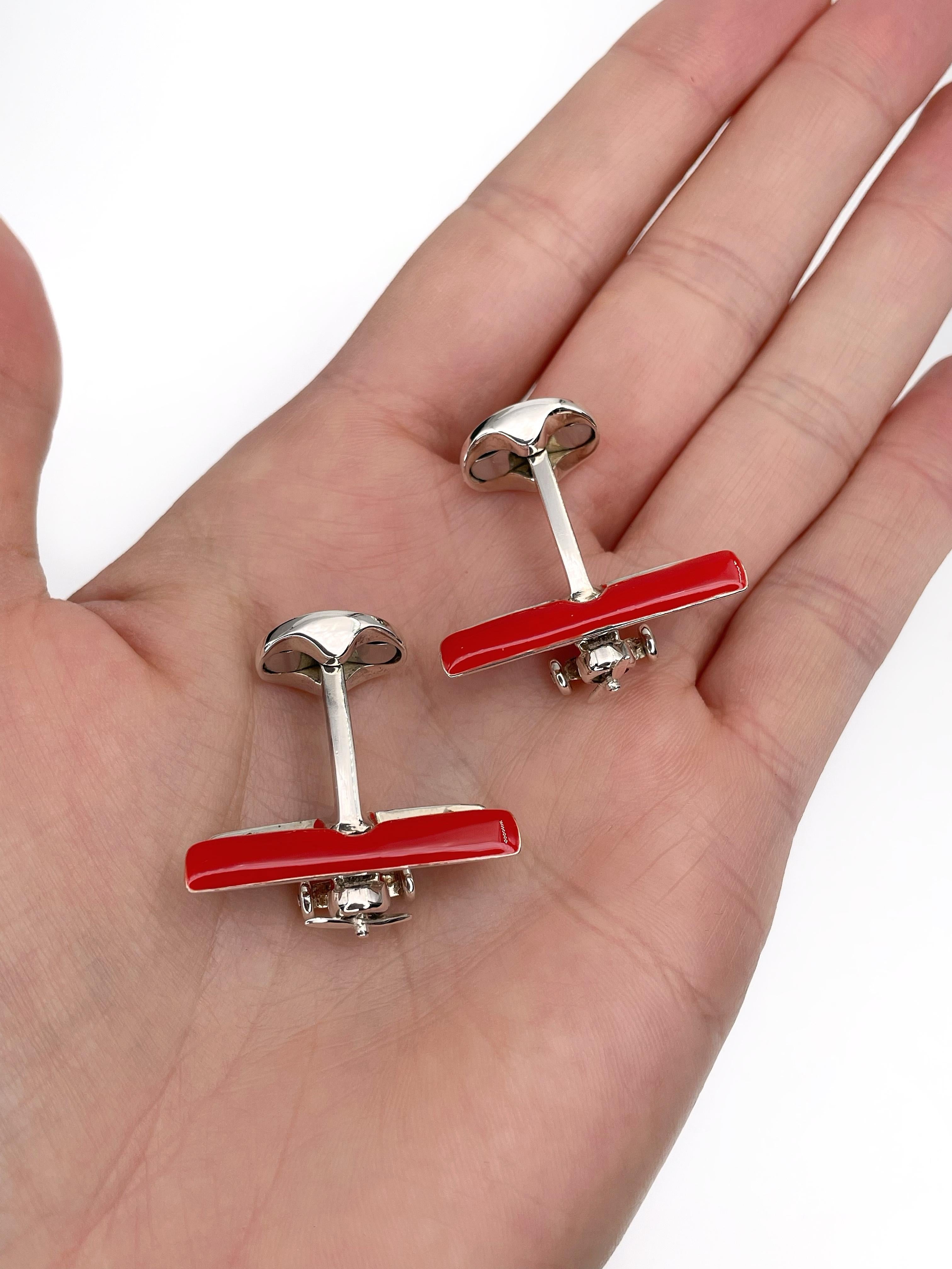 This is a playful pair of biplane cufflinks designed by Deakin & Francis in 2010’s. The piece is crafted in 925 sterling silver and is adorned with red enamel. It features rotating propellers. These cufflinks are very stylish and add a sense of