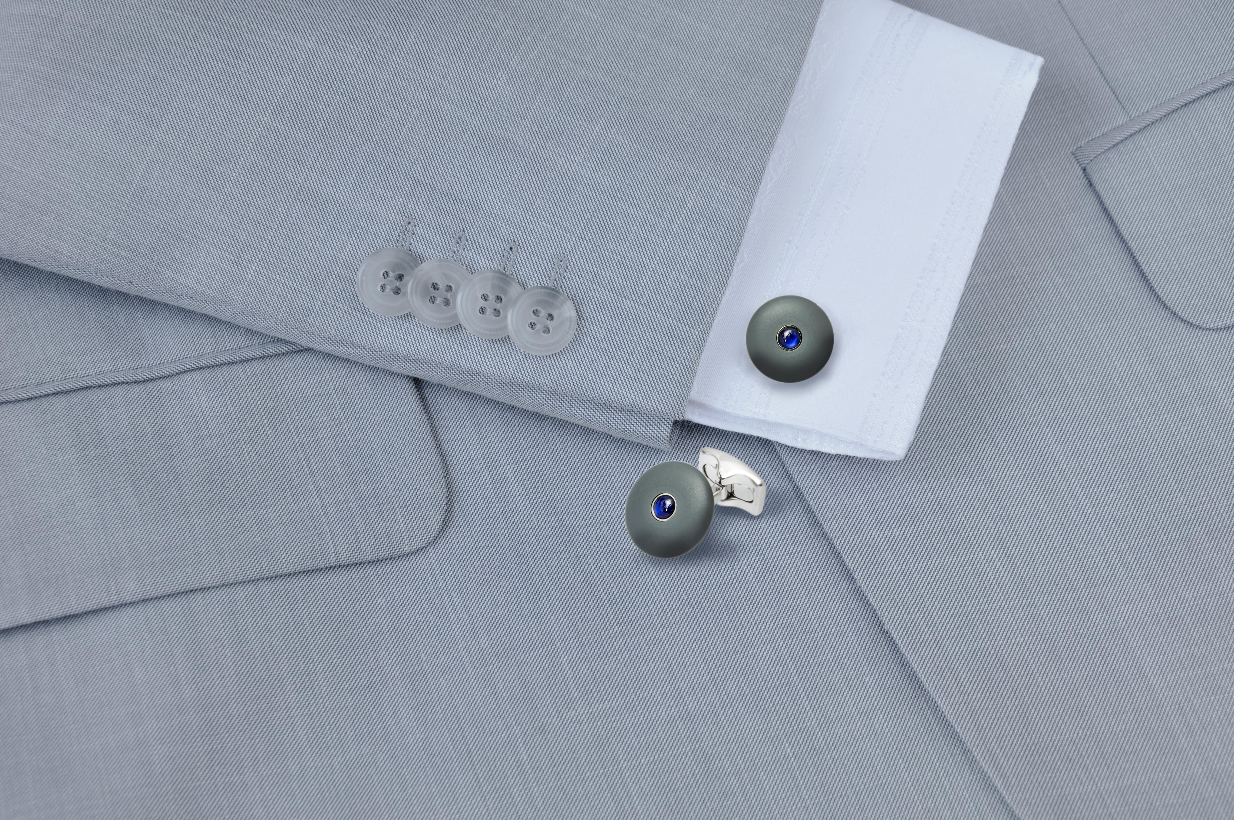 DEAKIN & FRANCIS, Piccadilly Arcade, London

Simple yet stunning, these round cufflinks have been crafted from cold cure enamel in a smooth grey finish and centred with a sparkling blue cultured cabochon sapphire centre. The most understated colour