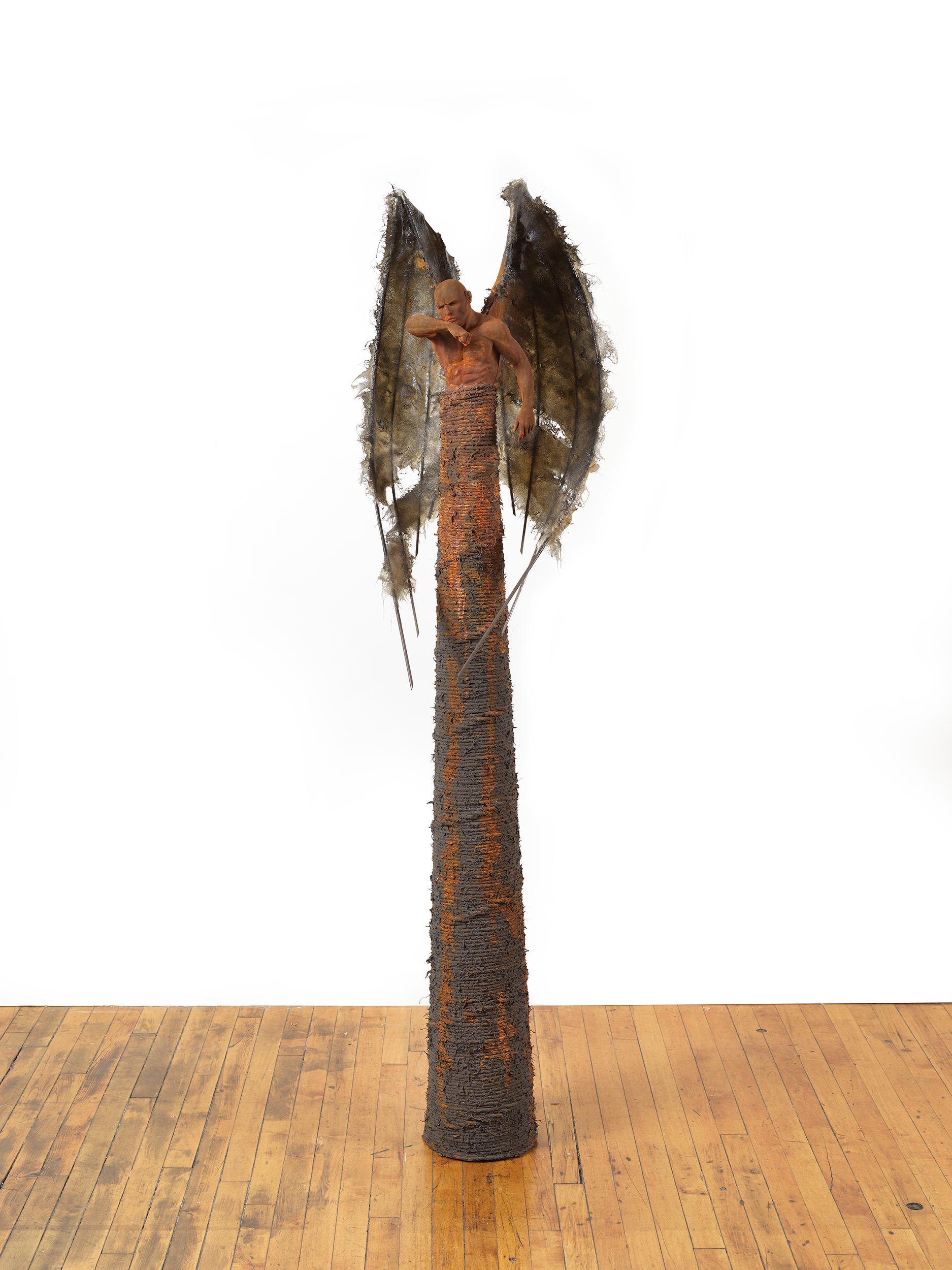 This winged cast bronze guardian figure sits atop a conical base is a pose of power and defiance, his bat-like wings made of fiberglass and steel envelop and protect him .  The sculpture is patinaed with iron and rust.  The combination of materials