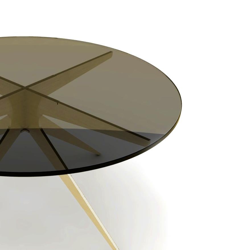 Inspired by silhouettes of Mid-Century Modern design, the dean round coffee table features a clear or smoked glass top which showcase the sculptural quality of the contrasted hardware below. Light and elegant in appearance, the stylish x-base is