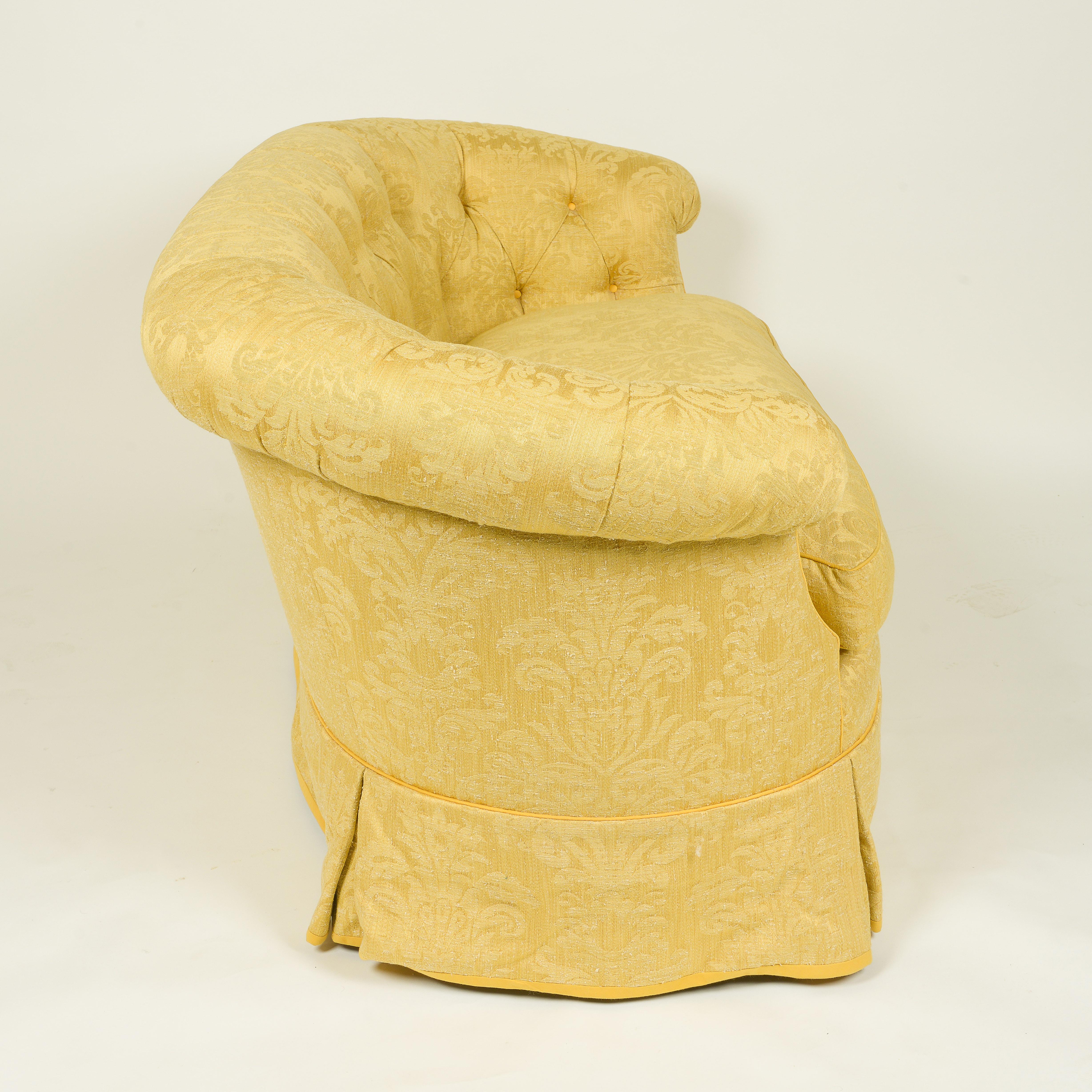 With rounded tufted back and loose down seat cushion. Custom made for Albert Hadley. Color is a deep golden yellow.