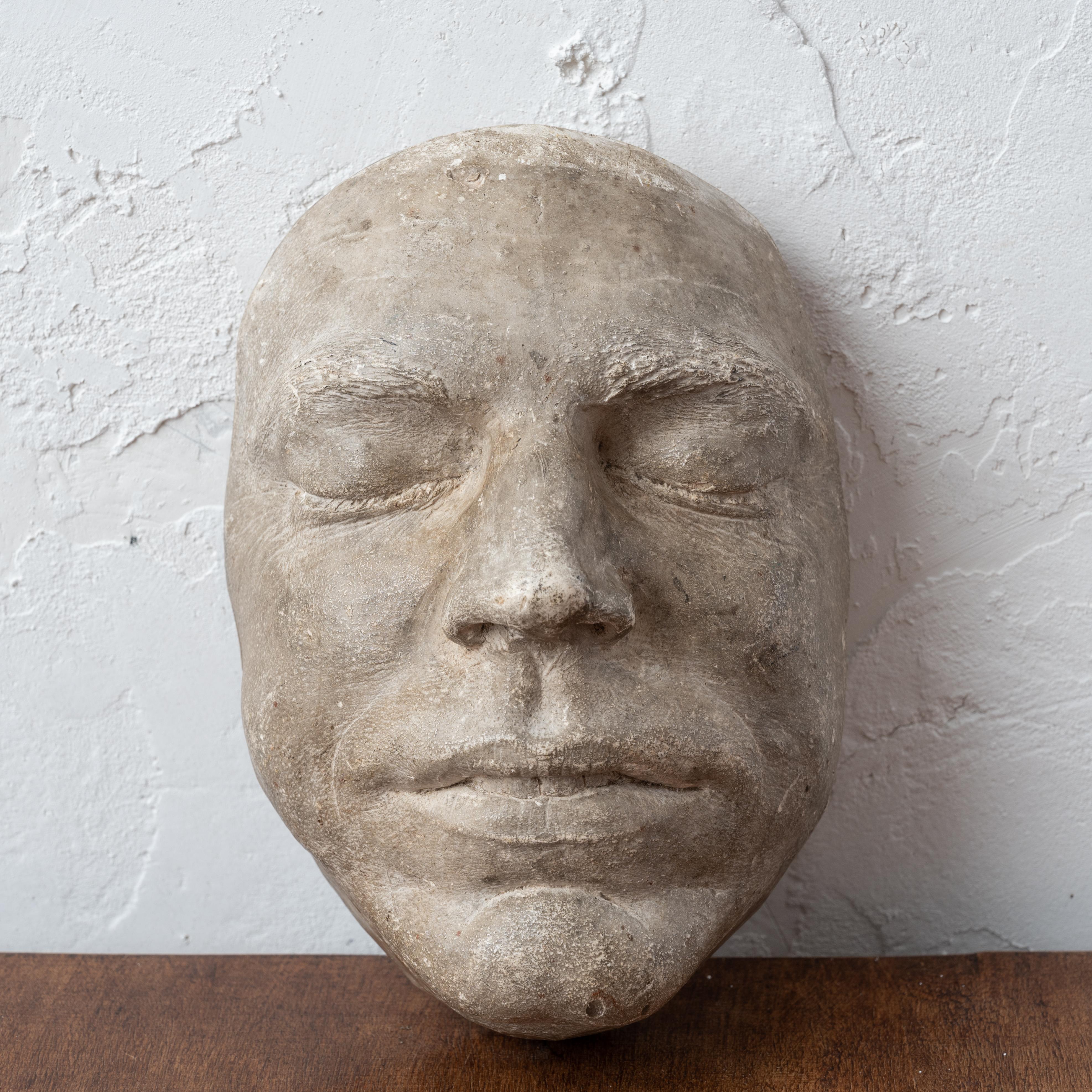 A plaster death mask, circa 1880. 

5 ¾ inches wide by 3 ¾ inches deep by 8 ½ inches tall

