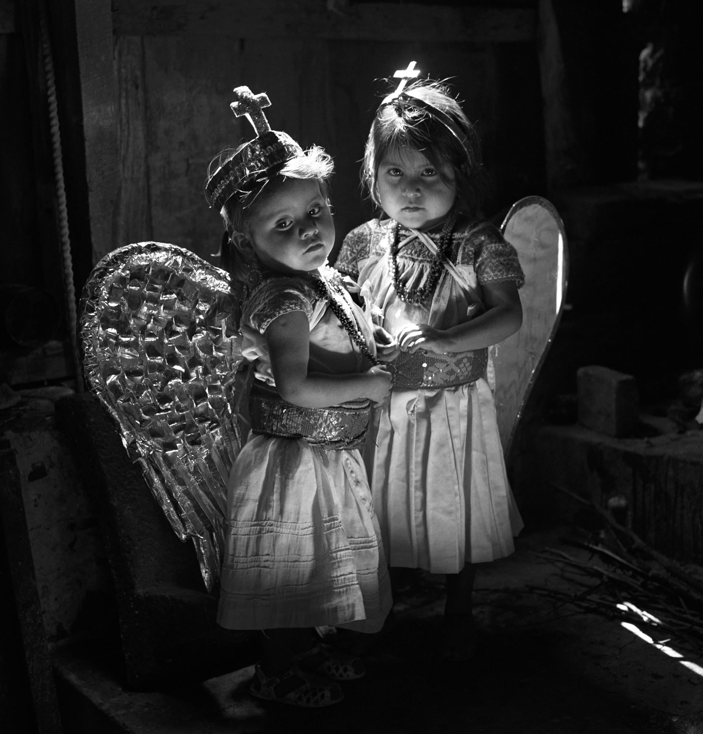 Debbie Fleming Caffery, Debbie Fleming Caffery. Rosa and Guadalupe, Mexico, (angels), 1997 (1998), gelatin silver print. Edition of 25. Image Size: 18.75 x 18.75". Matted: 24 x 24". 

Debbie Fleming Caffery grew up along the Bayou Teche in southwest