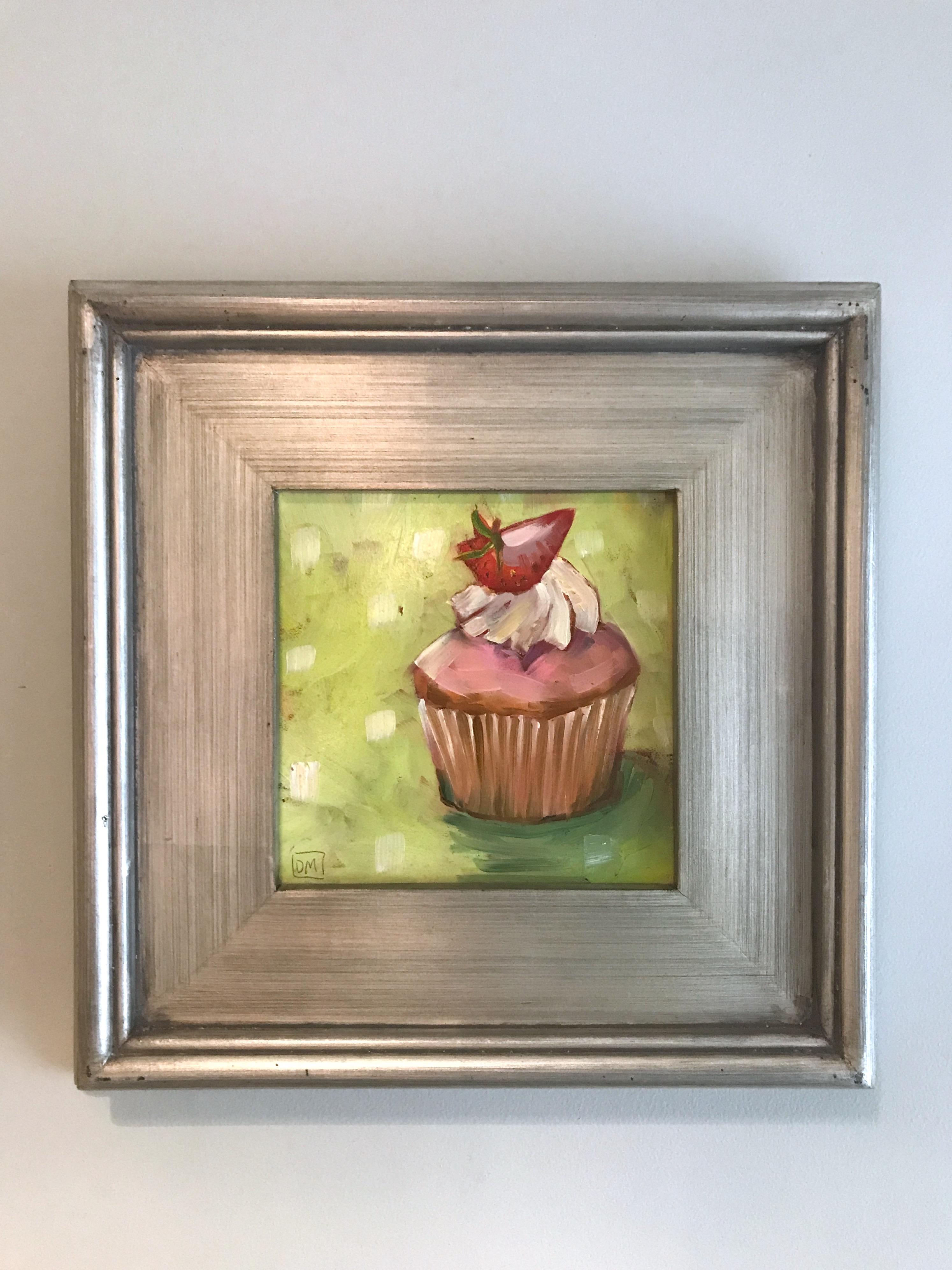 Debbie Miller Still-Life Painting - "Small Cupcake Still Life,  Pink/White Icing and Strawberry on Green with Dots"