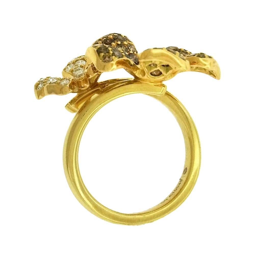 Luxury DeBeers 'Wildflower' collection double flower diamond ring, circa 2000, one blossom set with chocolate diamonds, the other with white diamonds, set in 18K yellow gold.  Measures 3/4