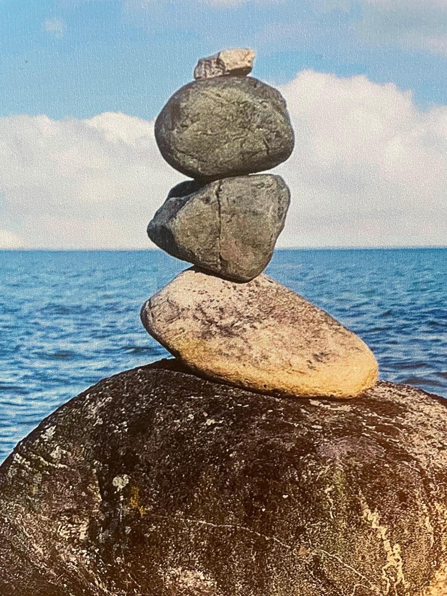 Anchor Bay in Chesterfield, Michigan is the location for this metallic print of a photographic image by Deborah Benedic.
Deborah created these stone inuksuks one afternoon on her neighborhood walk to mark her favorite view of the bay.
This large