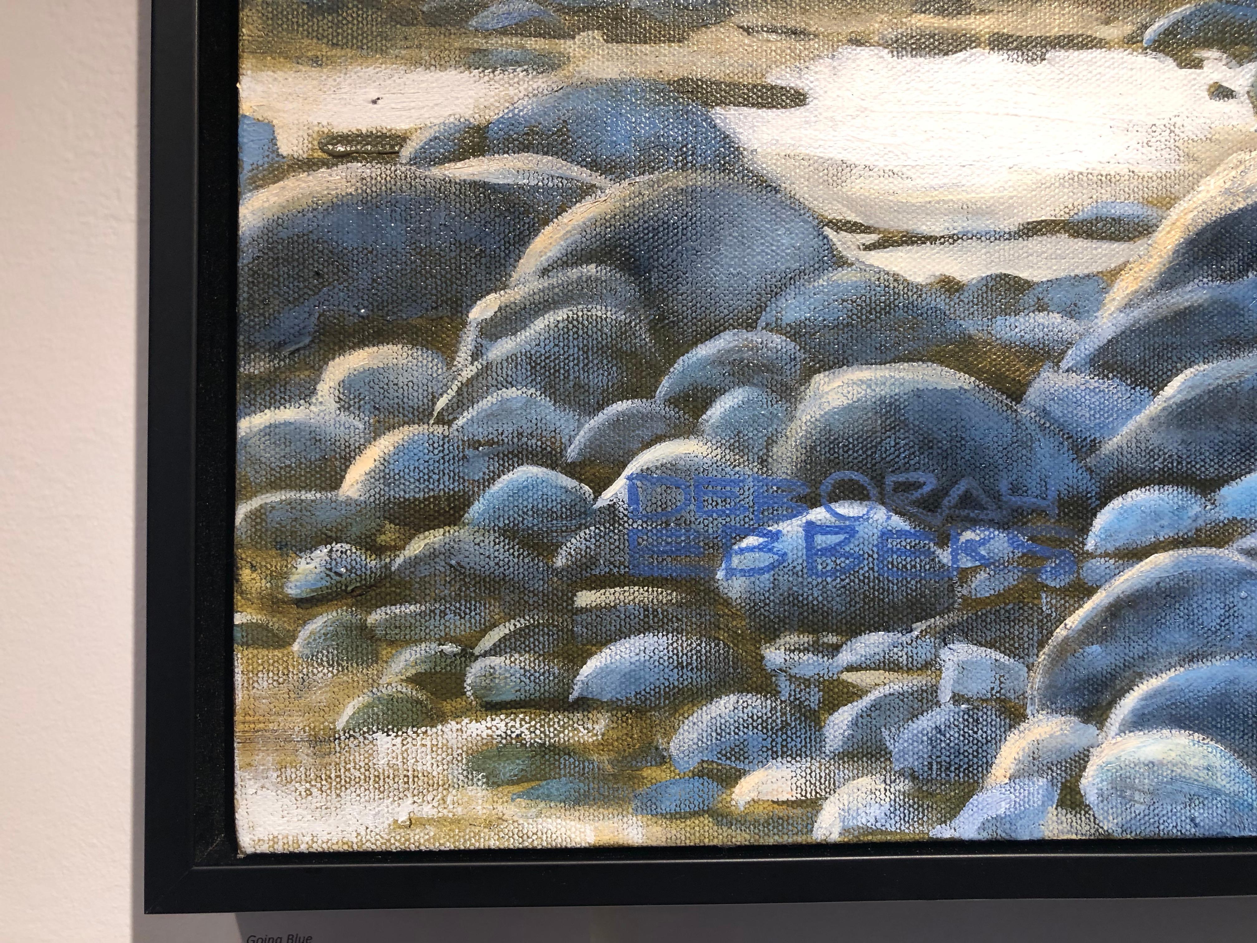 This oil on canvas painting of blue gray rocks and water lapping at the shore is beautifully painted in a representational style.  Upon close examination the brush strokes show an influence of impressionism.  The scene is saturated with bright