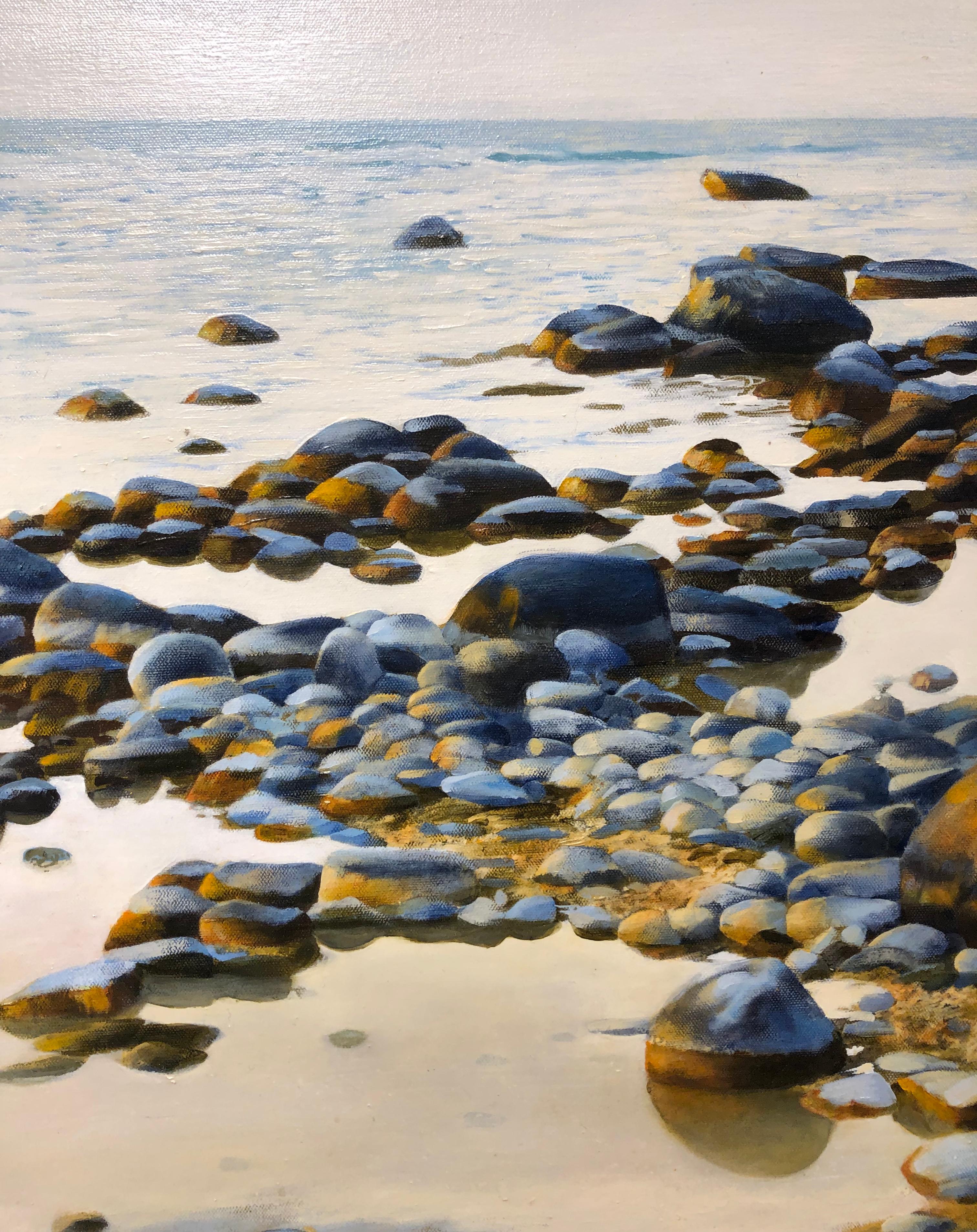 Along the rocky shores of Northern Michigan's Leelanau Peninsula, one might stubble upon this beautiful water scene.  The shimmering rocks, polished from years of water washing over them, are seen in a beautiful afternoon light.  The golden haze