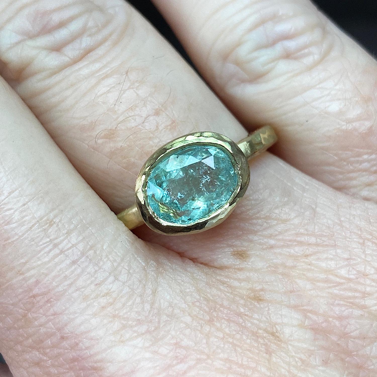 One of a Kind 18kt Yellow Gold Ring by Deborah Murdoch is from the Abundance Collection featuring an oval 1.70ct Blue Paraiba Stone. The ring band is slightly planished giving that textural feel and has a silky satin finish.

Metal: 18kt yellow