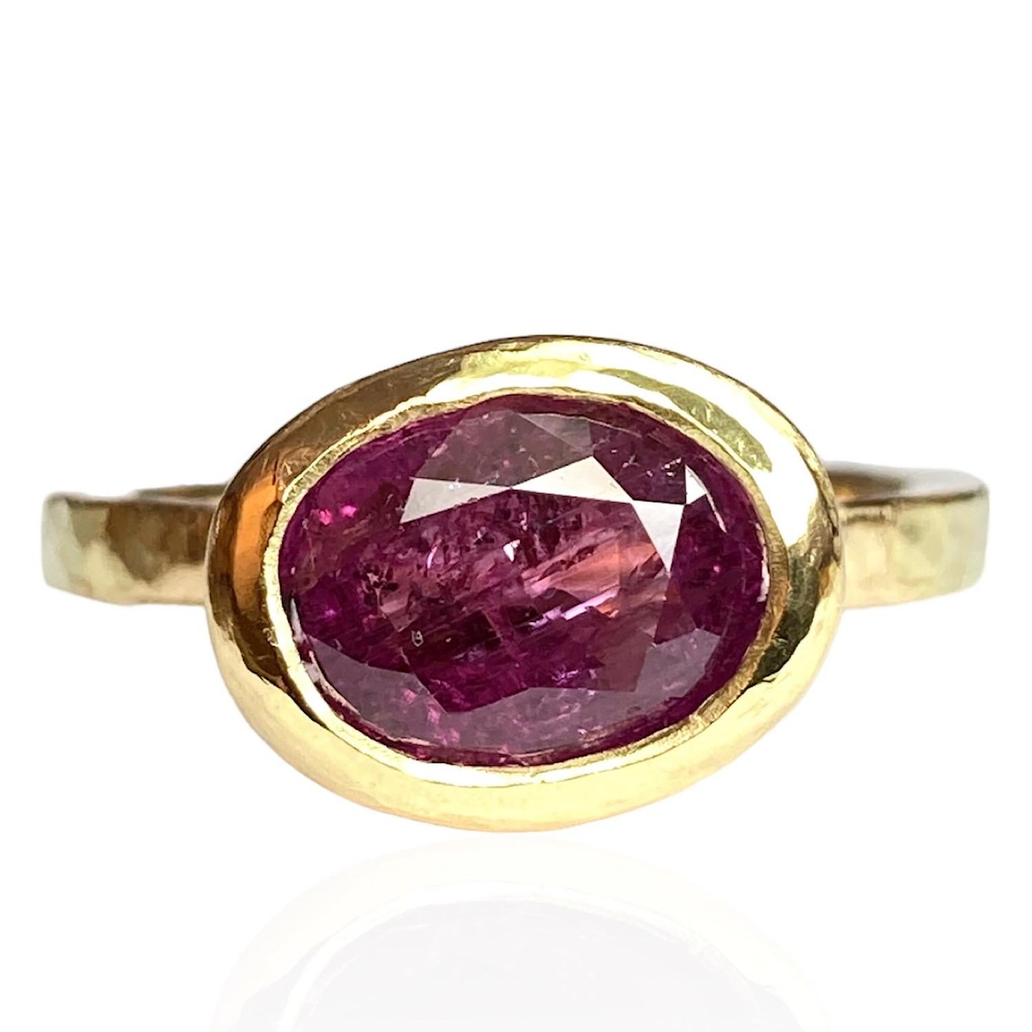 One Of A Kind 18ct Yellow Gold Ring by Deborah Murdoch is from the Abundance Collection featuring an oval 2.82ct Rich Pink Sapphire Stone. The ring band and setting is slightly planished giving that textural feel and has a silky satin