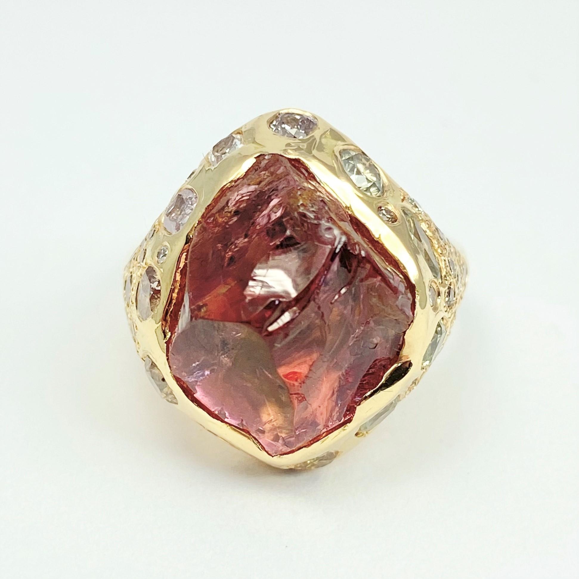 The one-and-only Sune Erosion ring, from our Watu Collection, is hand-crafted with 18-karat recycled yellow gold, and showcases one untreated, Tenda Cut, natural color pink tourmaline; eleven flush-set colored diamonds in various shapes, sizes, and