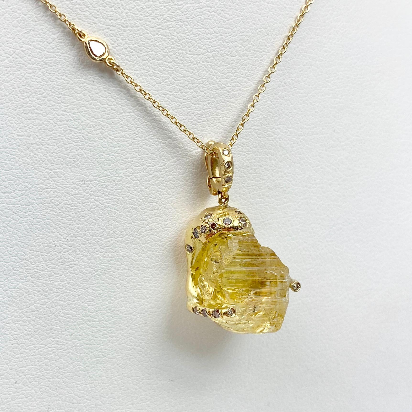 The Esther pendant necklace, from our Watu Collection, in 18 karat recycled yellow gold. Pendant features one untreated natural color, Tenda cut yellow scapolite (a type of feldspar), and 23 round natural color accent diamonds. Pendant is finished