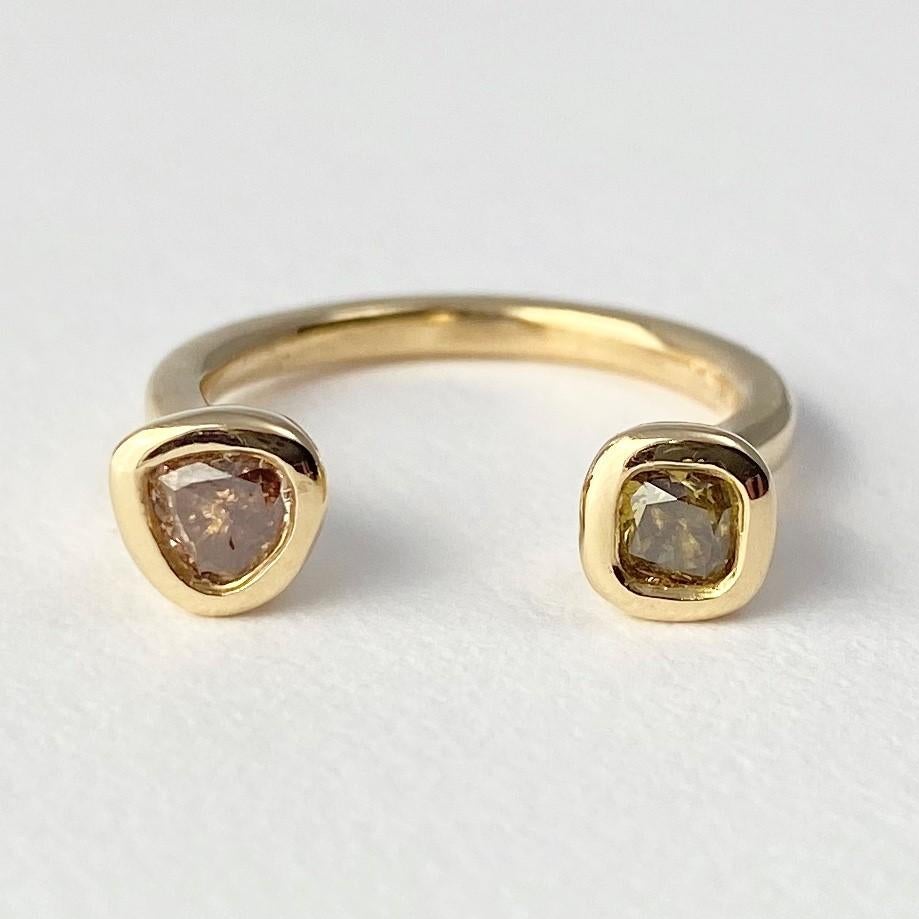 The very first of Debra's designs is the Leap of Faith ring, from our Barefoot Collection. Hand-crafted with 18-karat recycled yellow gold, and featuring two bezel set, colored diamonds (one pear shape, and one cushion). The space between the two