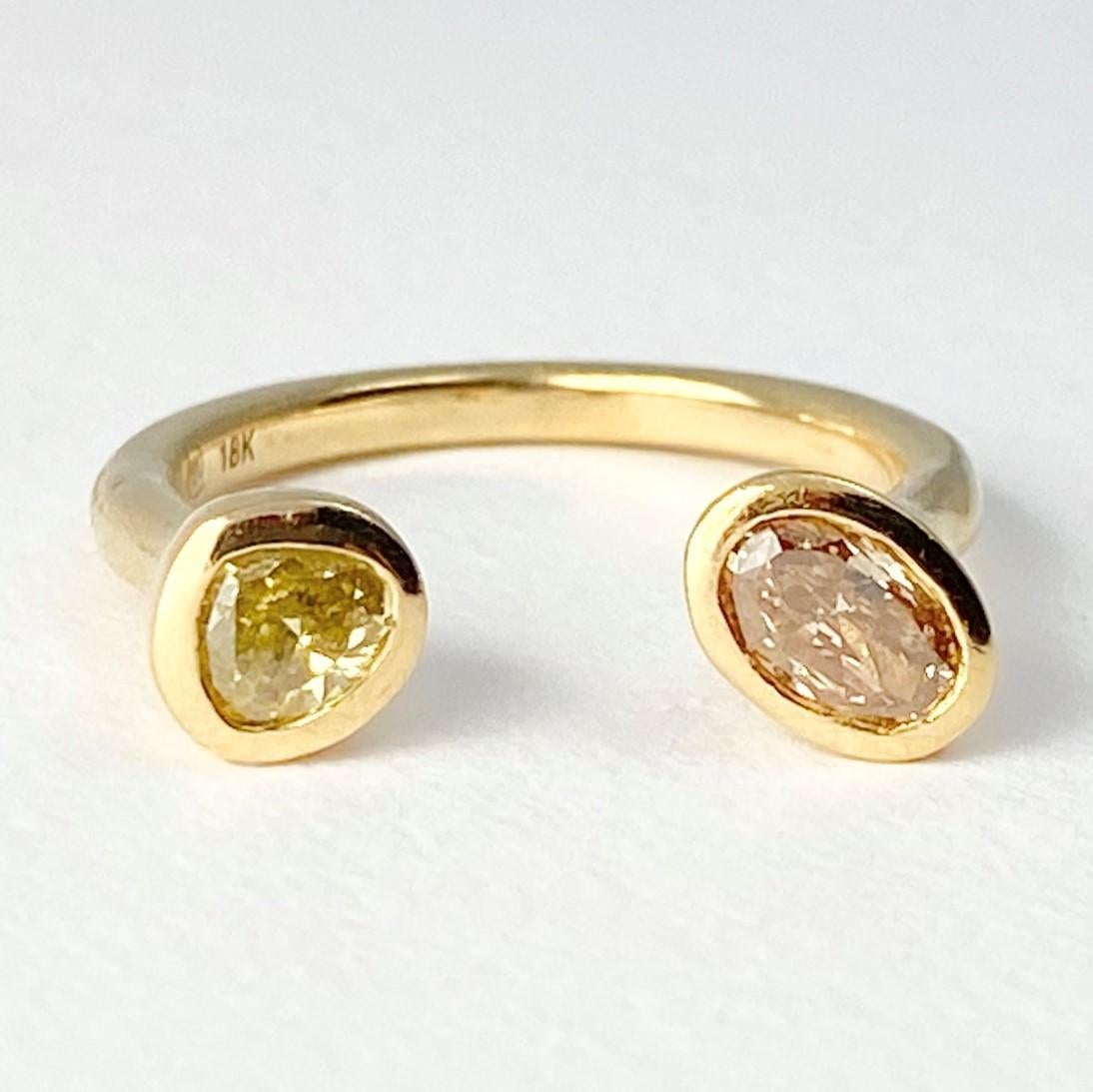 The Leap of Faith ring, from our Barefoot Collection, is the first of Debra's designs. Individually hand-crafted with 18-karat recycled yellow gold, and showcasing two bezel set, colored diamonds (one oval shape, and one pear). The space between the