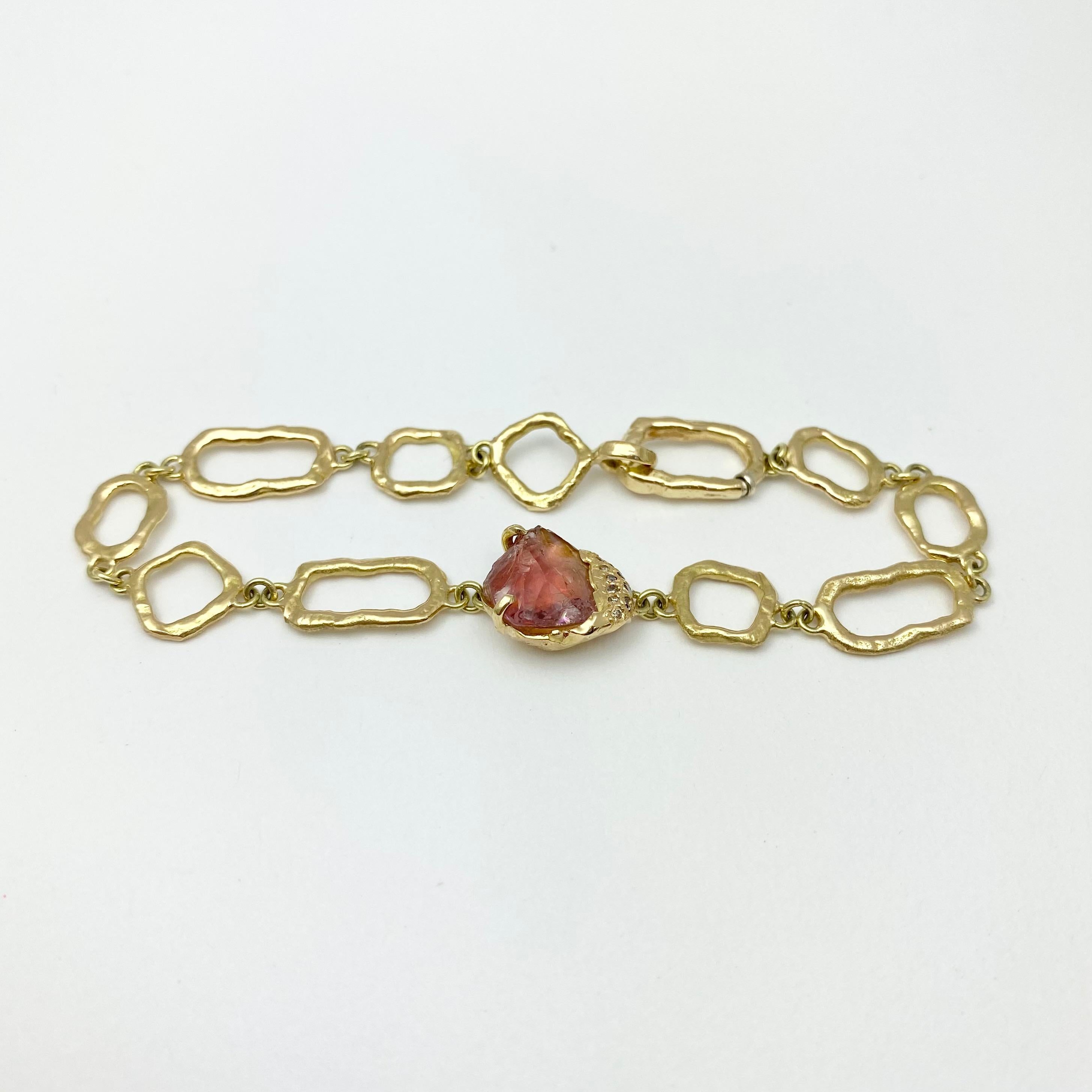 The Gladwell on Links bracelet is hand-crafted with 18-karat recycled yellow gold, and features one untreated, Tenda Cut, natural color pink tourmaline; and 11 round champagne accent diamonds. The Gladwell bracelet incorporates links of our own