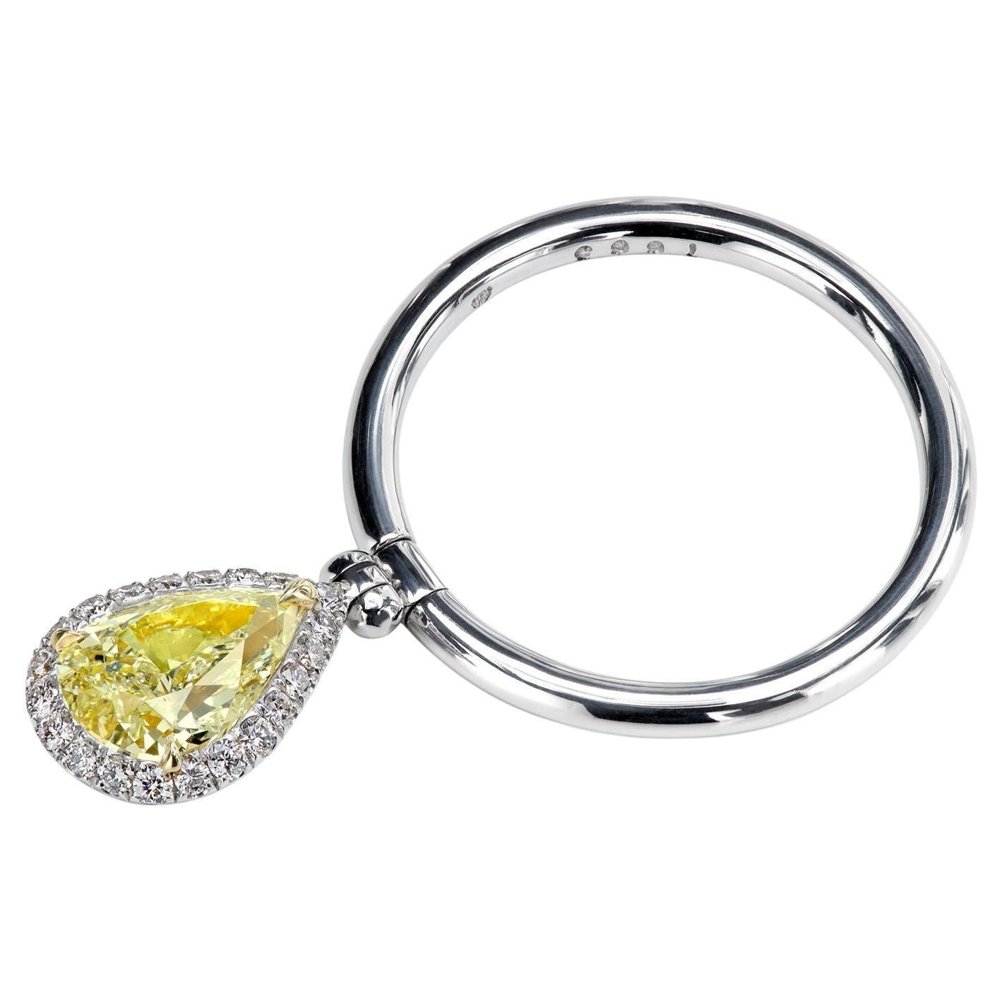 A charming 1.03-carat fancy yellow diamond in a micro pave halo pivoting on a clean, smooth platinum shank. With micro pave on both sides to enhance the experience, the exclusive Leon Mege double-sided reversible ring is designed to impress and