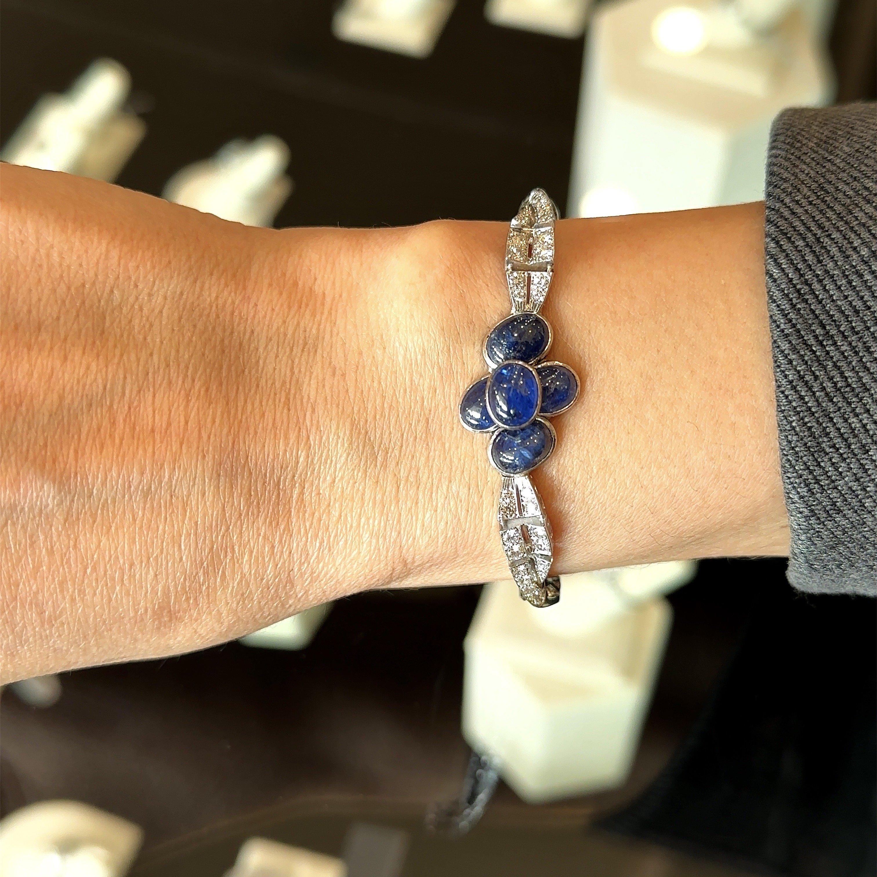 This Beautiful Vintage Bracelet Dates from The 1950’s.
It’s Crafted in Platinum.
It Features Five Stunning Oval Blue Cabochon Sapphires 
They Weigh 5.10 carats.
There are 3.40cts of Brilliant Round & Baguette Diamonds that are Set in an Elegant