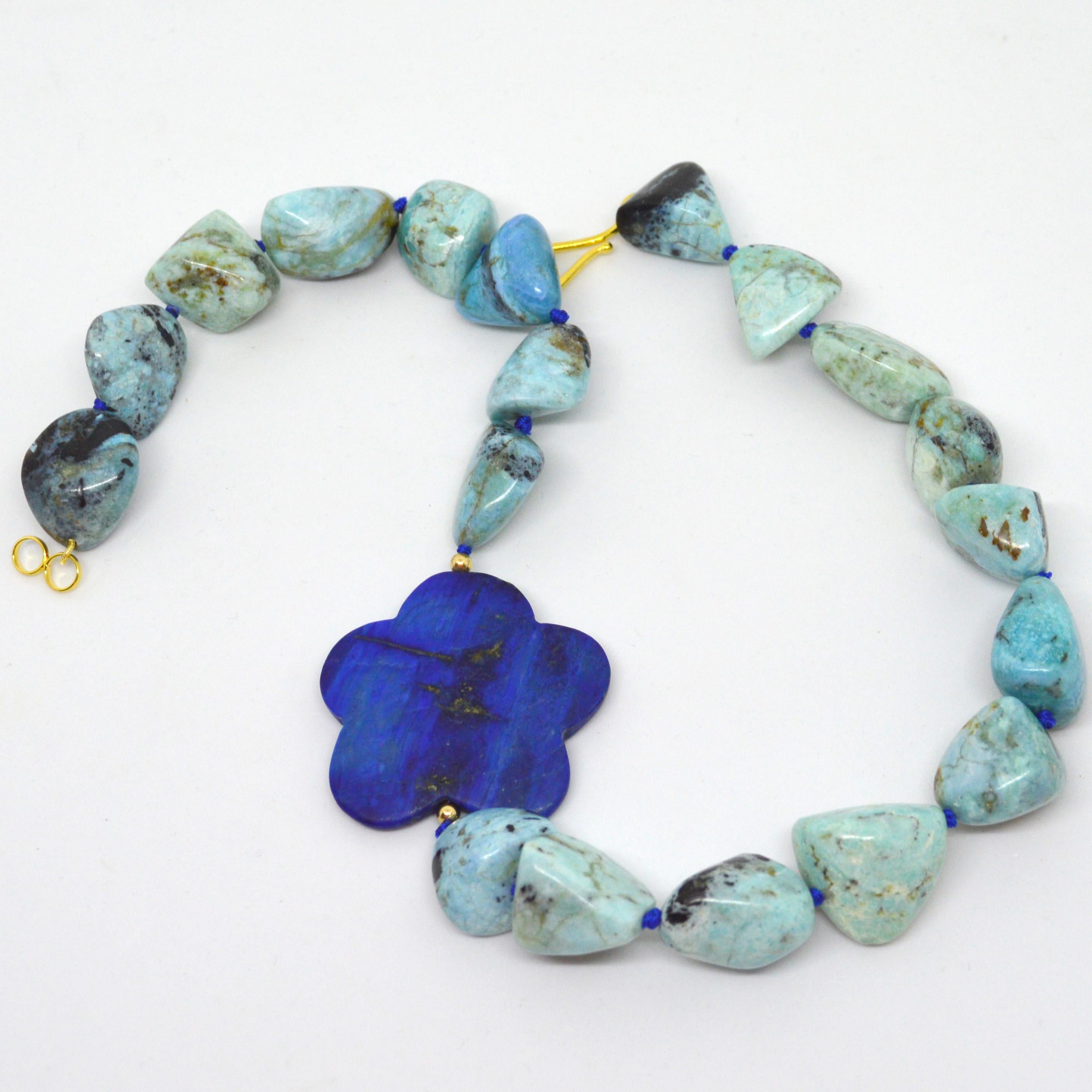 Beautiful vibrant blues of African Blue Opal nuggets approx 25mm long with an offset 45mm stunning Lapis Lazuli flower bead, 4mm Round Gold filled beads with a 37mm Gold Plate Sterling Silver Hook clasp, hand knotted for strength and