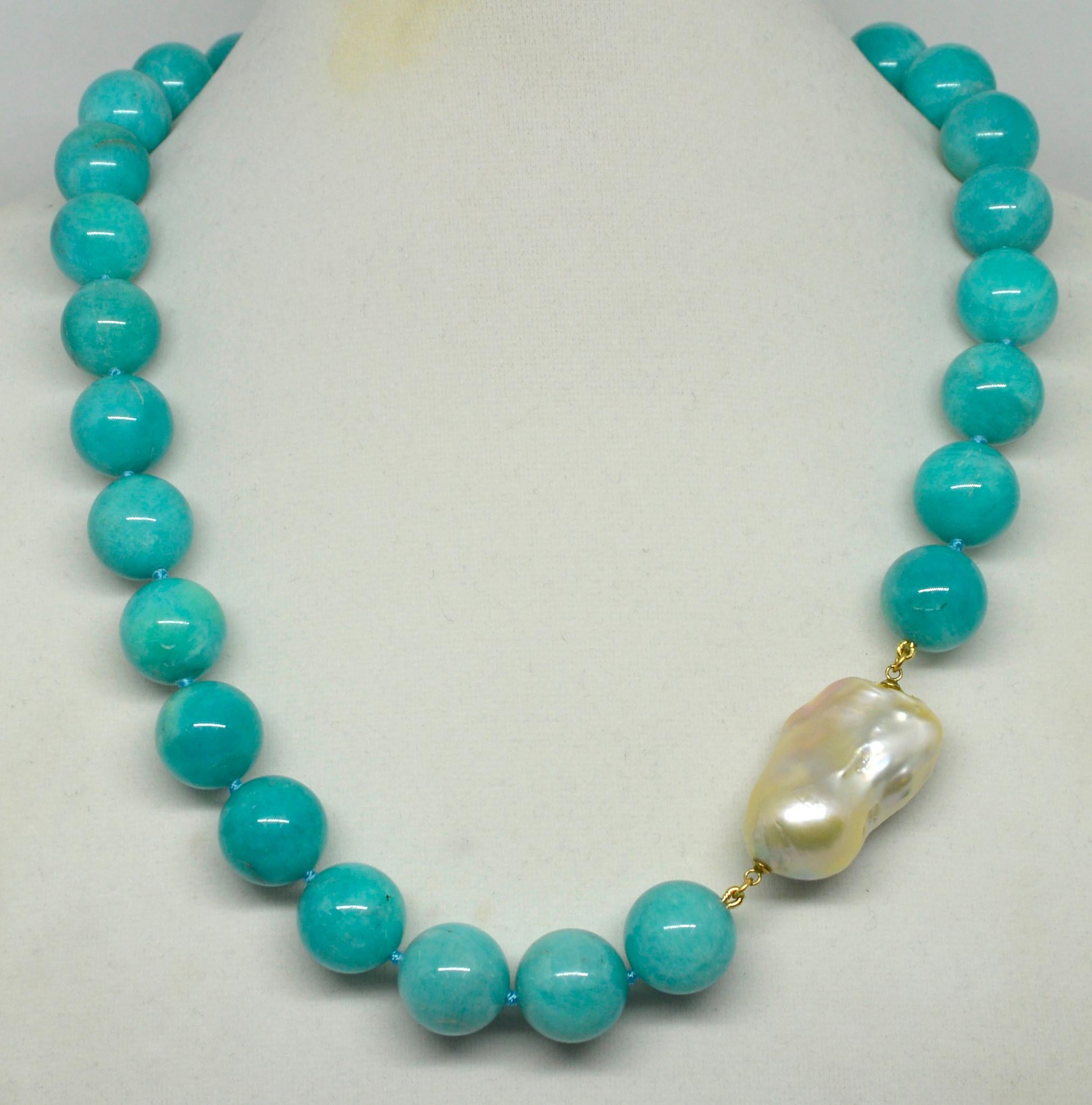 Amazonite Fresh Water Baroque Pearl Necklace

Bold and Beautiful this Vibrant Blue/Turquoise Amazonite Necklace is all Natural from Mother Earth. Necklace has 26 x 16mm Peruvian Round Amazonite, offset with a Fresh Water Baroque Pearl 34x16mm