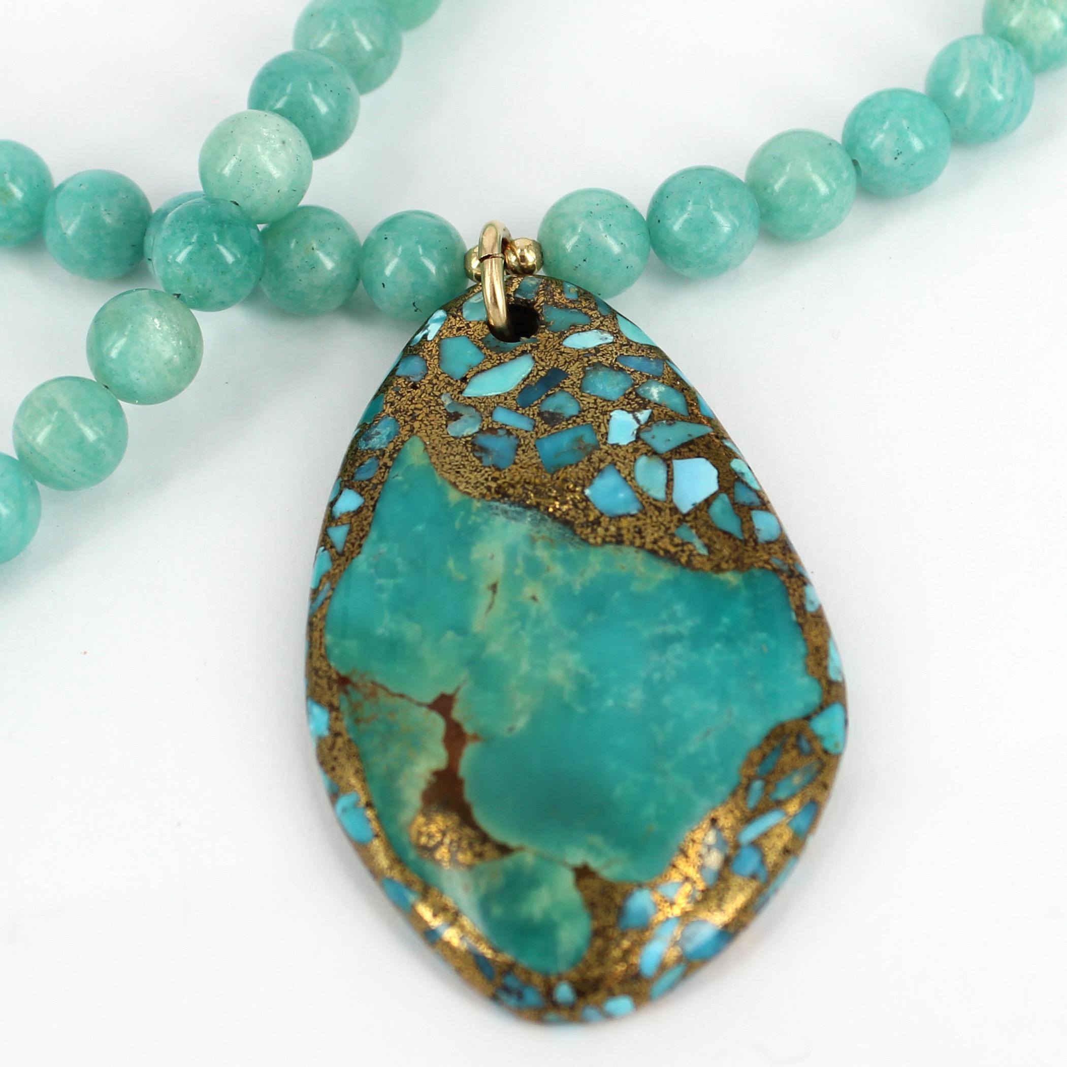 This delicate Amazonite Necklace is Vibrant in colour and is complemented with a Turquoise free form Pendant 
 
Description Amazonite Polished 8mm
                    Pendant  56.5x35.5cm  (Pendant is made of Turquoise slices set into compressed