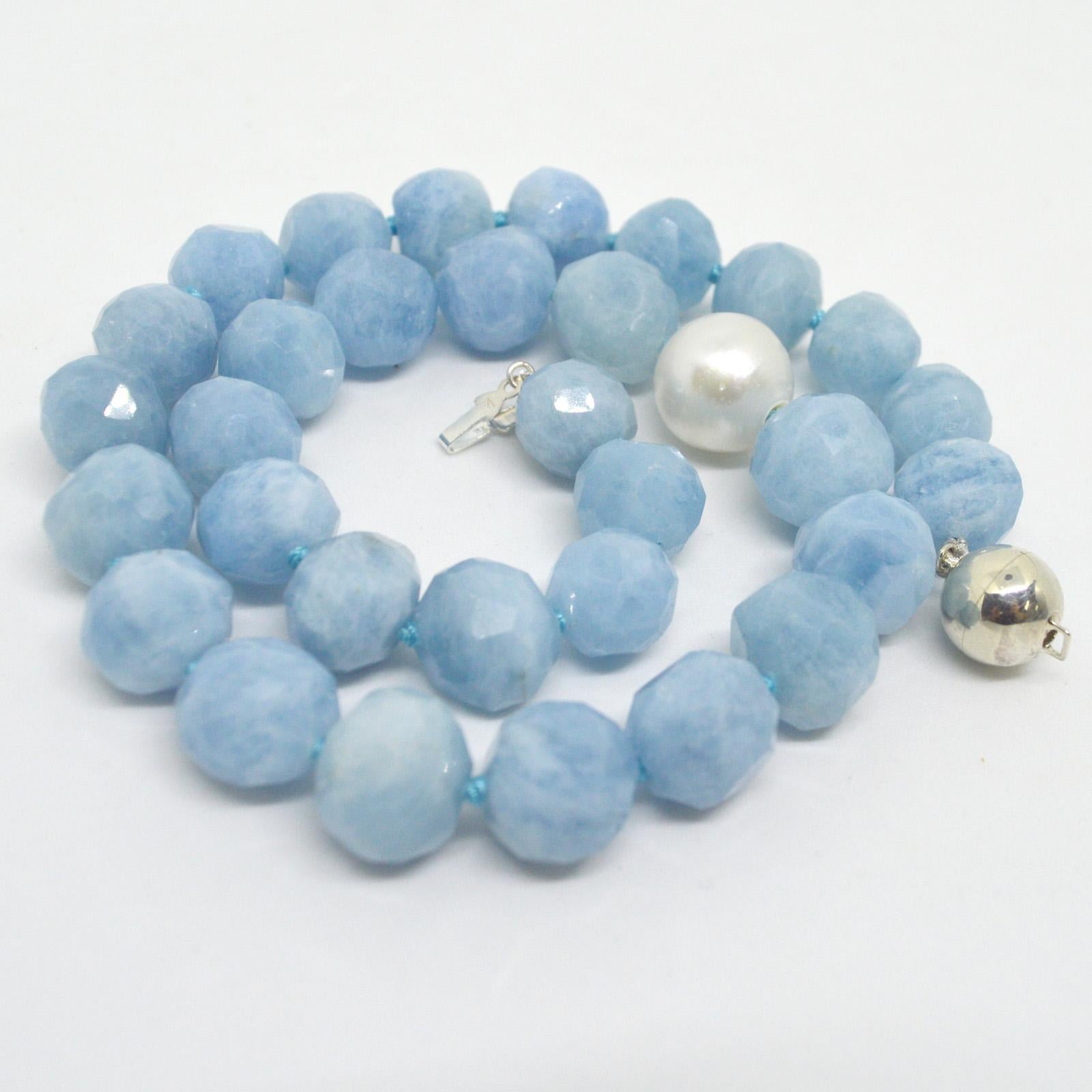 Aquamarine faceted Faceted round nuggets approximately 15mm wide with an off centre Australian South Sea pearl 15mm.
Hand knotted on matching aqua thread with a 12mm sterling silver clasp.
Finished necklace measures 45cm 