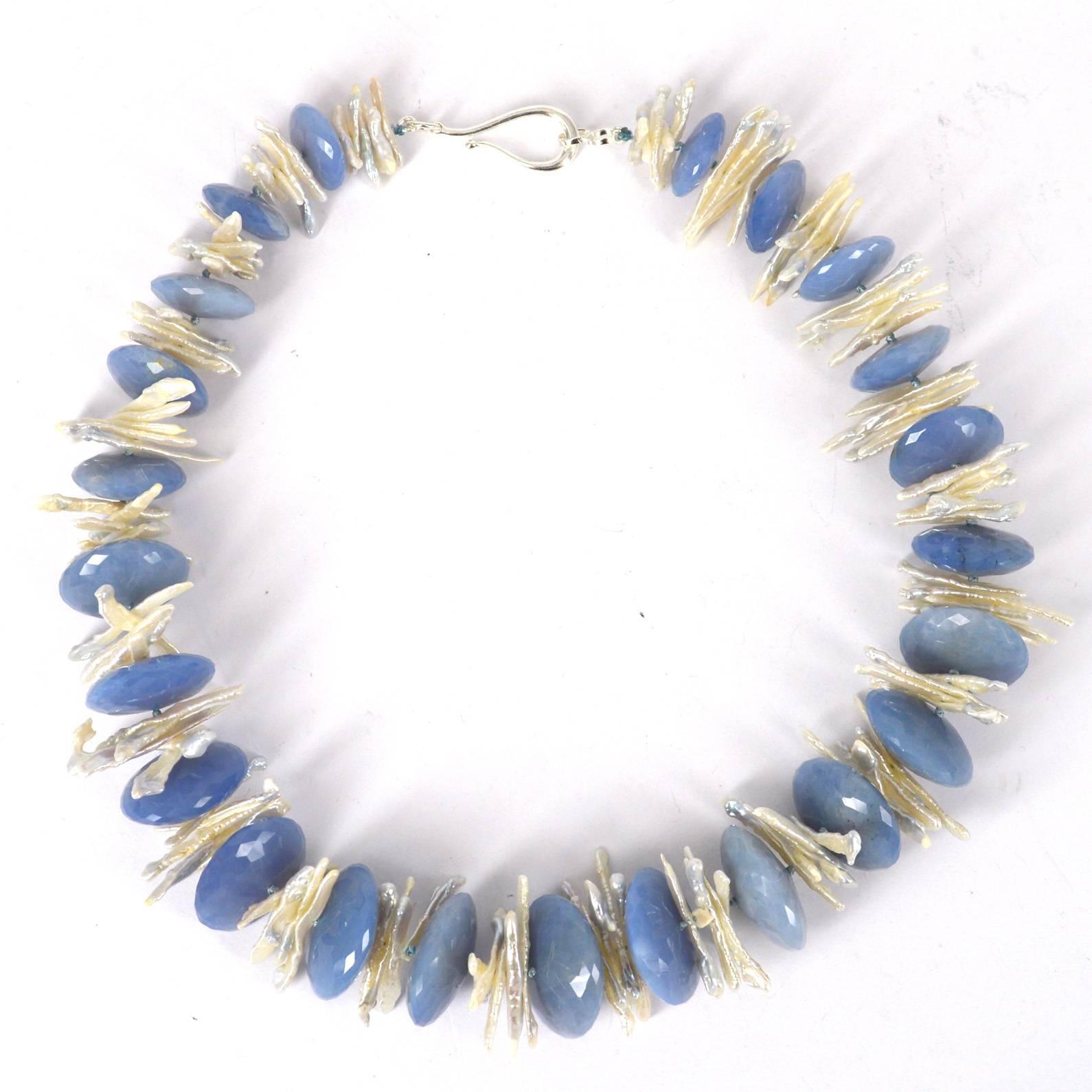 Natural Blue Chalcedony Graduated faceted Saucer beads up to 10-25mm sepererated with Natural Grey Tipped Biwa Fresh Water Pearls finished with a 30mm Sterling Silver Hook Clasp, Hand Knotted for strength and durability.

All Stones are Natural