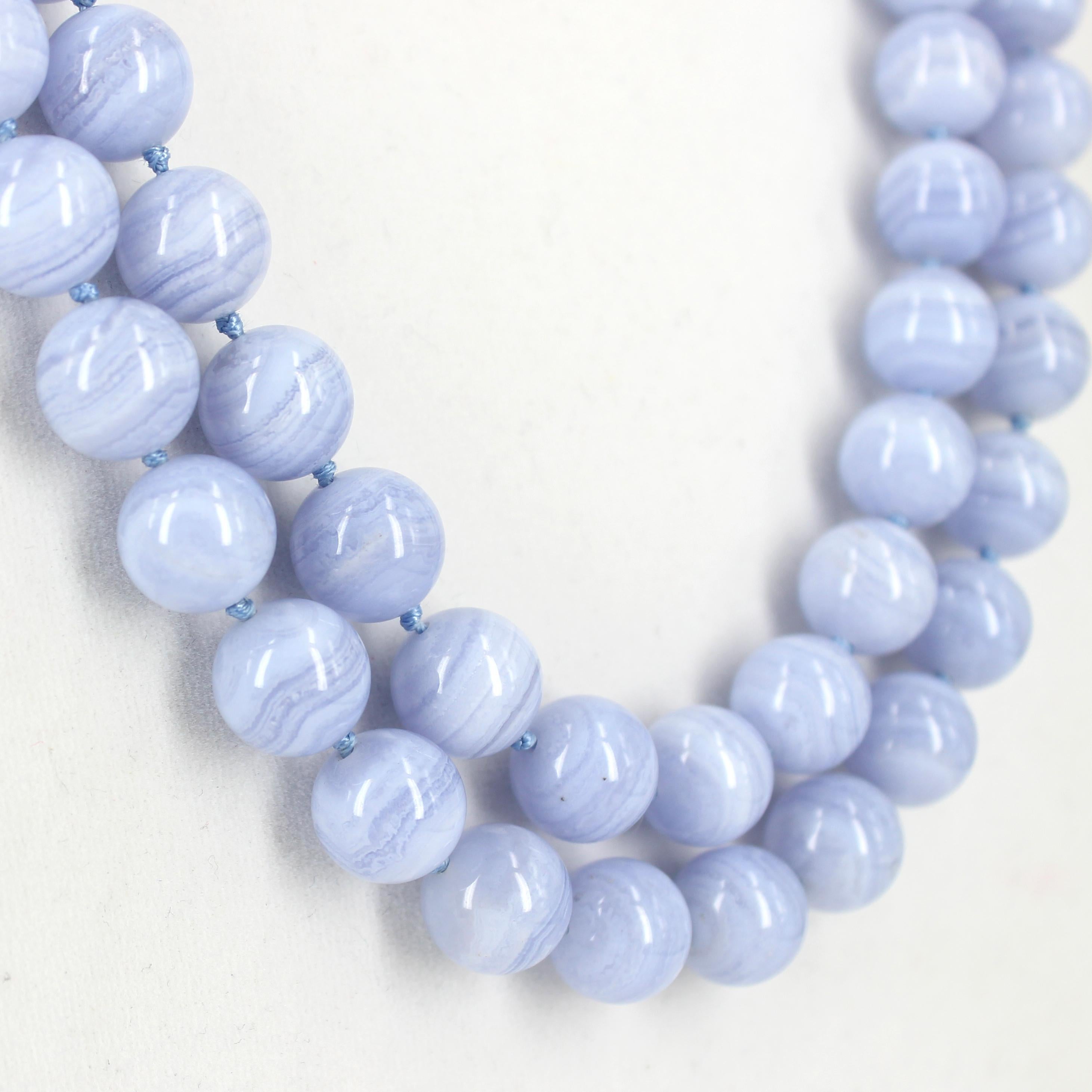 This elegant Blue Lace Agate offers a comfortable fit without compromising style,  beautiful waves of banded layers predominantly light blue in colour. 

Description 12mm Blue Lace Agate Round 
                    Sterling Silver Clasp 23x25mm
     
