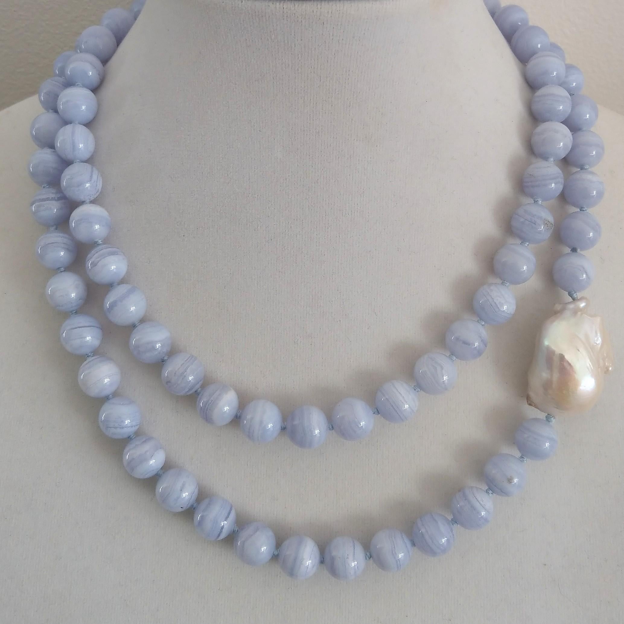 Statement strand of 80 high quality 10mm polished Blue Lace agate beads hand knotted on matching blue thread with a large Baroque Pearl 30x17mm. 
Finished necklace measures 92cm/36.2 inches.
