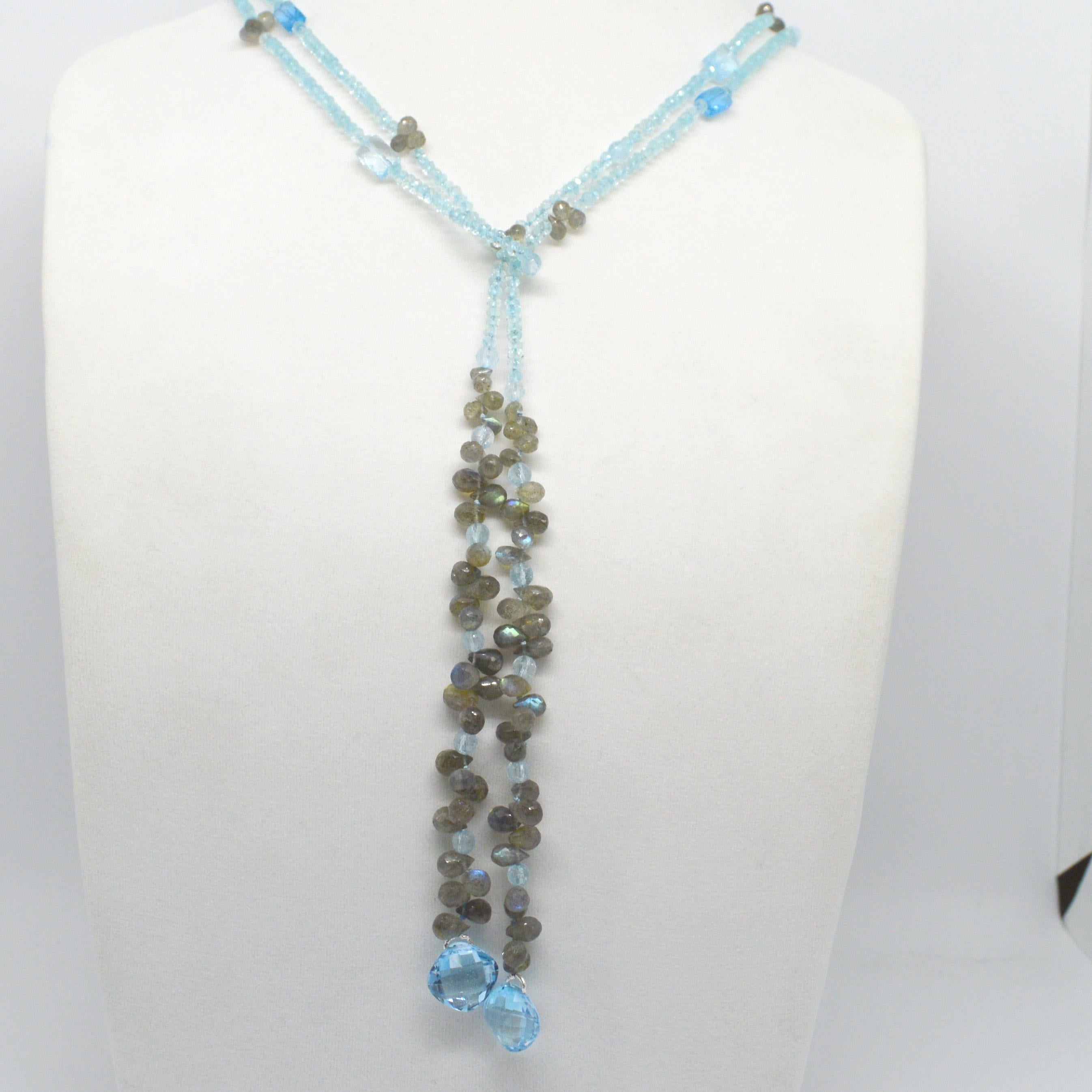 Versatile scarf style lariat necklace with 3x2mm Faceted Blue Topaz beads, 10x4mm Faceted Labradorite Teardrop beads,  14mm Faceted double sided checker board cut Blue Topaz beads. Hand knotted for strength and durability.

Total length 1.5m 60