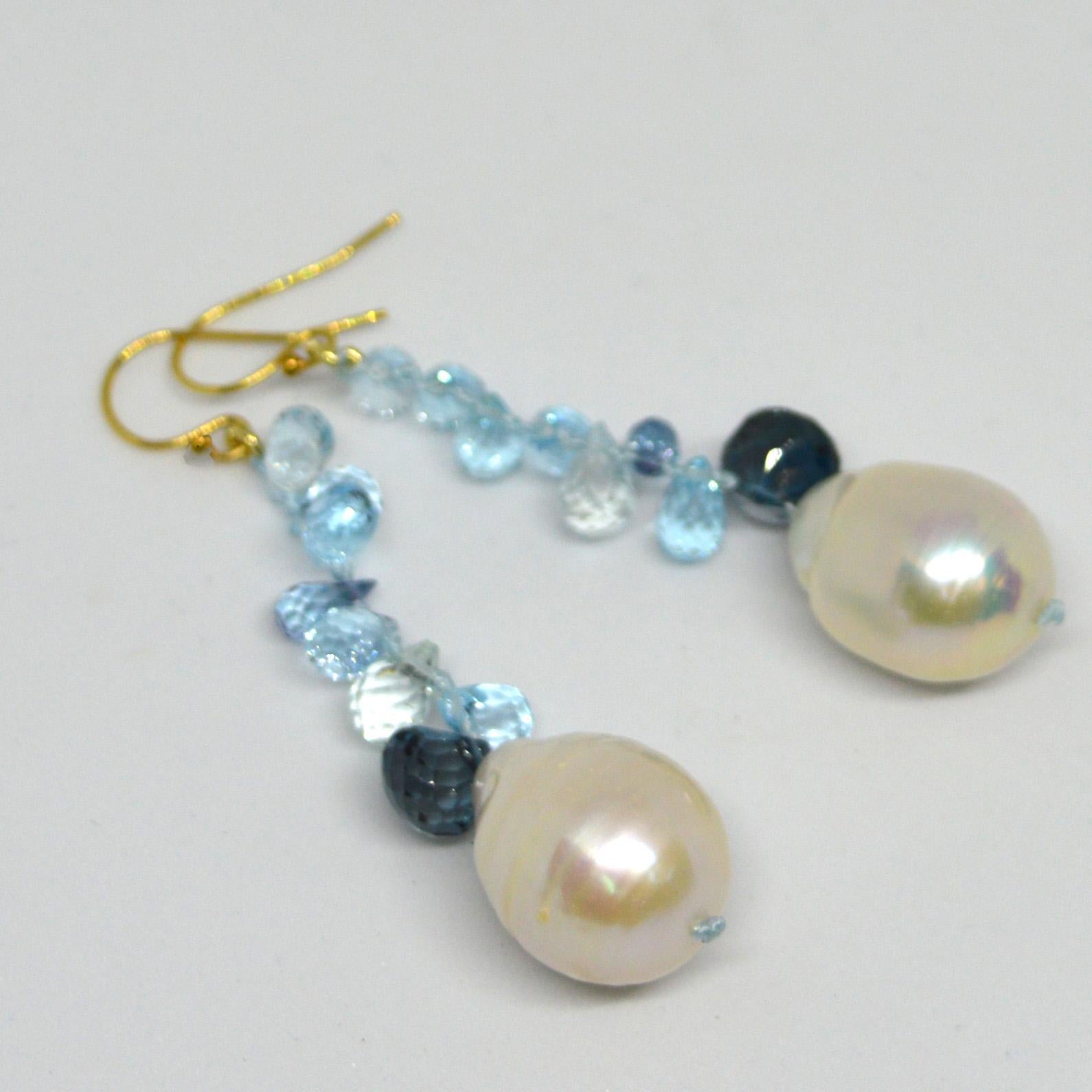 Sparkling Blue Topaz and London briolettes  sit on top of 18x14mm Fresh Water Pearls hand knotted on blue thread with a  14k Gold filled sheppard.

Total Earring length 63mm.