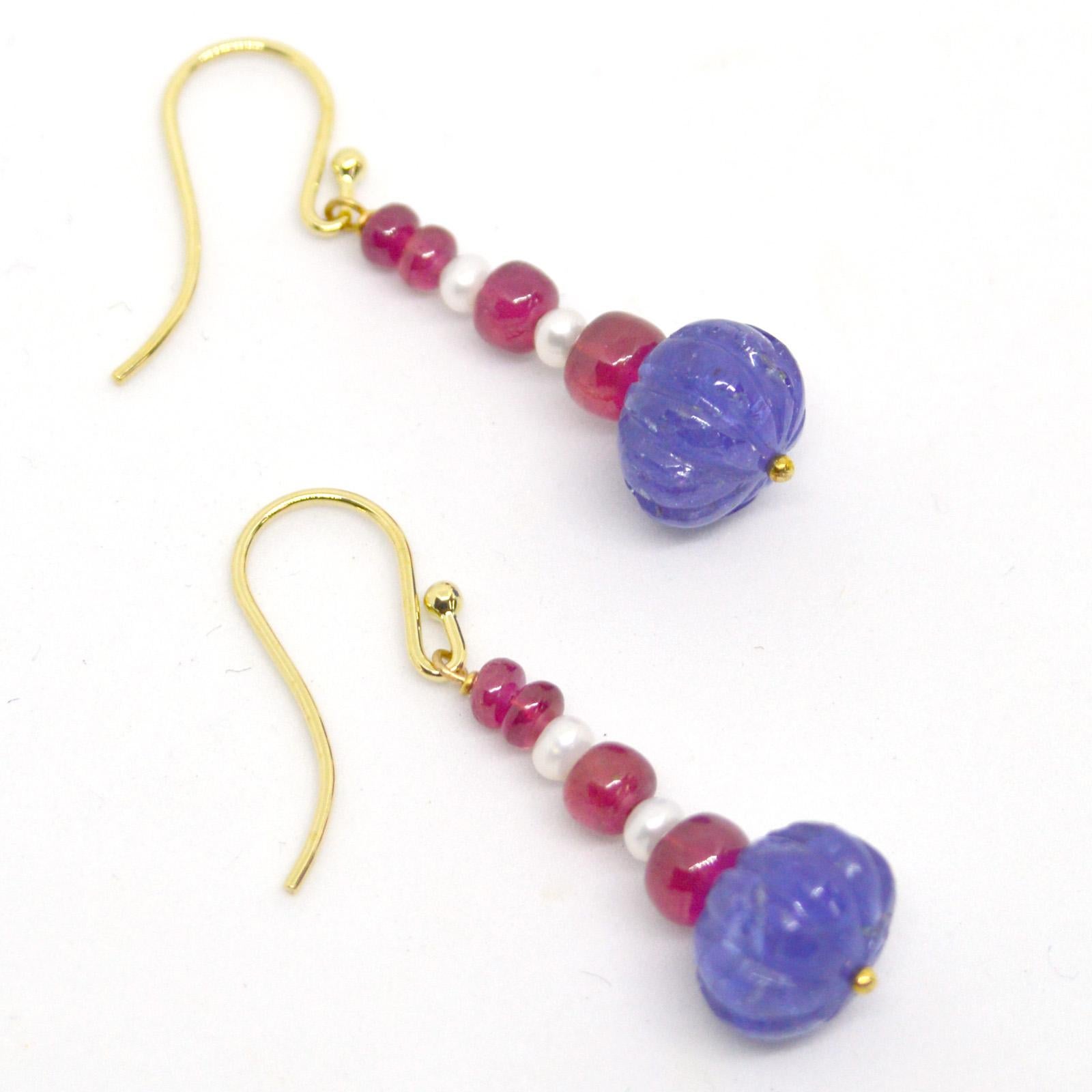Carved Tanzanite melon shaped beads 8x12mm with 3mm Fresh Water Pearls and 4 Polished rondels of Natural Burmese Rubies on each earring graduating from 5.6x4.8mm down on 9kt Gold sheppard and headpin
Finished Earrings measures 40mm  1.57 inches
