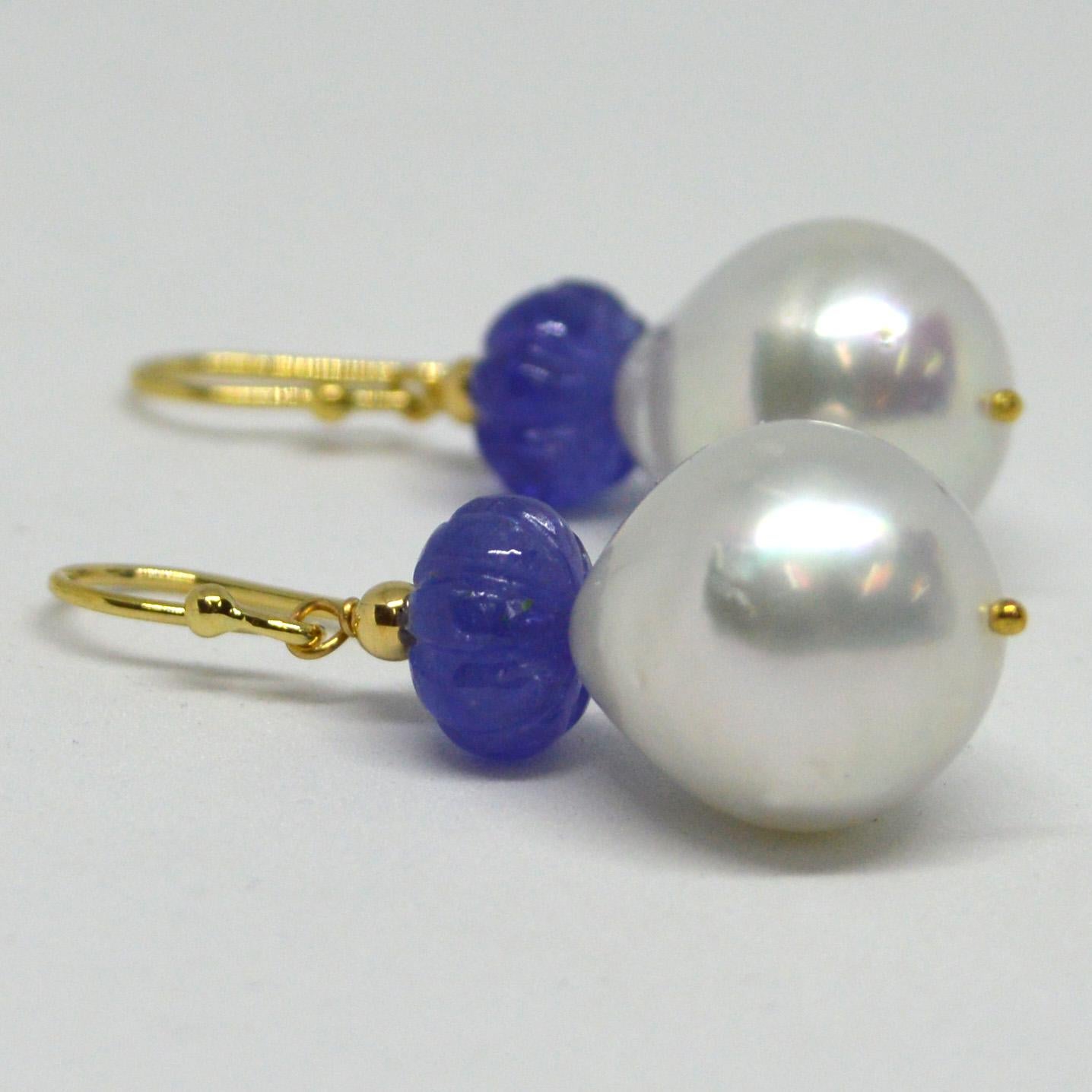 Natural Carved Tanzanite 9.3x5.6mm with 15x14mm high sheen South Sea Pearls set on 9ct yellow Gold Sheppard,  14k Gold head pin and 3mm round bead.

Total Earring length 40mm.