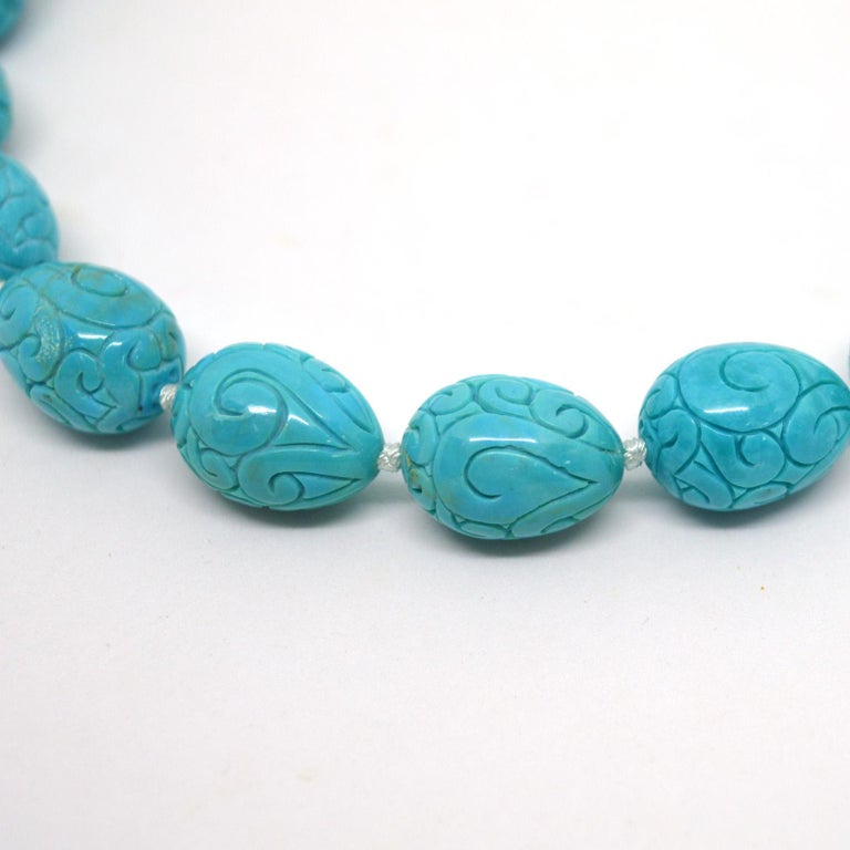 Unique high quality carved 15x20mm  Turquoise teardrop bead necklace, hand knotted Rhodium plate CZ Sterling Silver hook clasp 
Total length of necklace 48cm.

