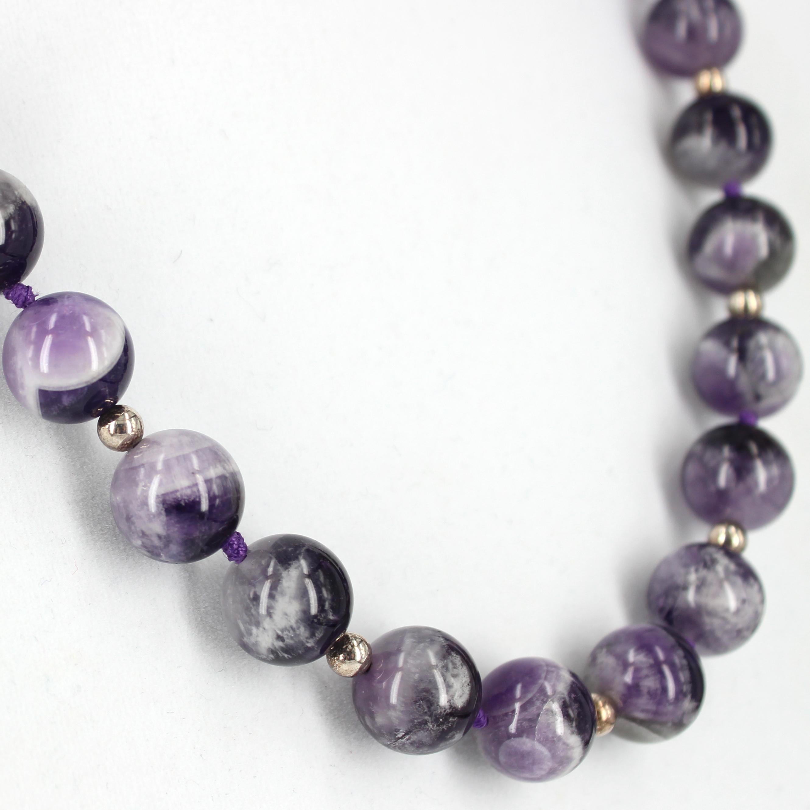 
Chevron Amethyst  14mm Polished Round Bead Necklace 54cm Knotted in Sections

Descriptions Chevron Amethyst  Round Beads 14mm 
                      Sterling Silver Round Beads 5mm 
                      Hook Clasp Sterling Silver 