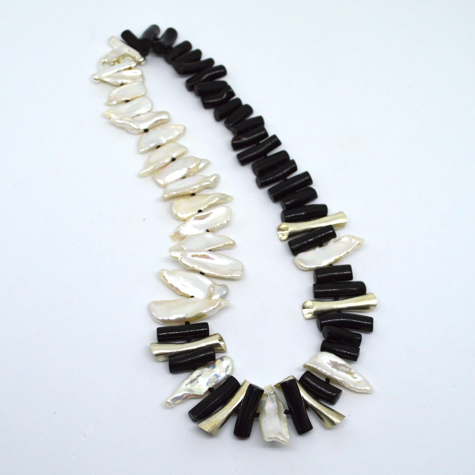 Statement necklace of Fresh Water Keshi Pearls approx 30mm with black coral sticks and sterling silver tube beads hand knotted on black thread with a Sterling Silver clasp. 

Finished necklace measures 52cm.
Shipped in a Jewellery Box.