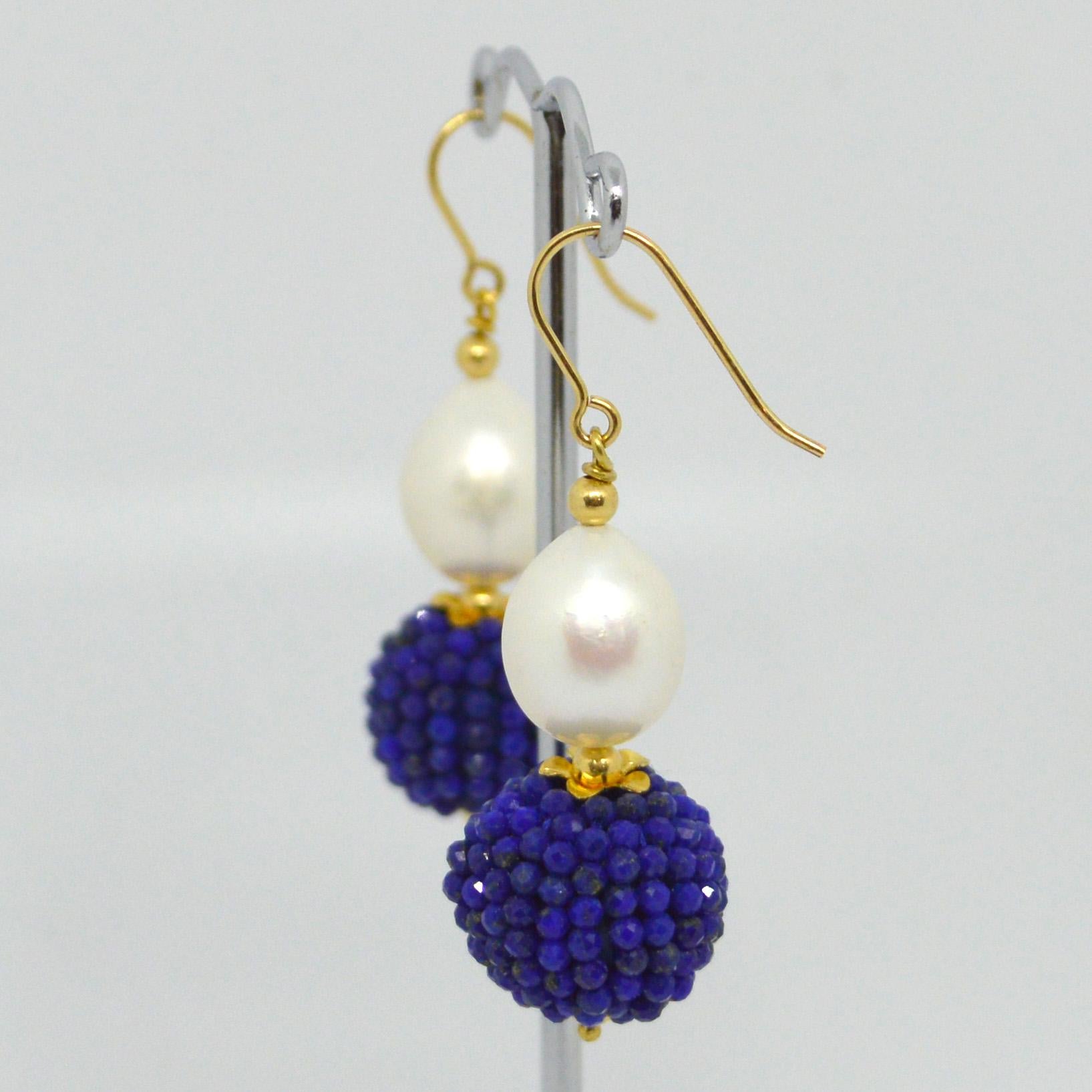 Natural Freshwater Pearl 15x10mm with a hand made beaded bead of natural Lapis Lazuli mirco faceted beads 14k Gold Filled headpin and 3mm beads and Sheppard.

Total Earring length 48mm.
