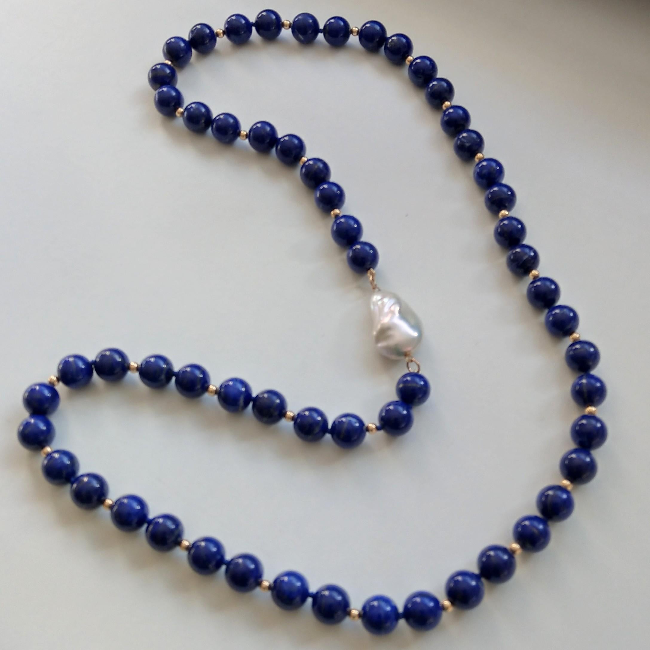 Matinee length natural Lapis Lazuli beads 12mm hand knotted on blue thread with 4mm Gold filled beads and a 30x19mm high grade natural baroque Fresh Water Pearl
Total length of necklace 90cm.

