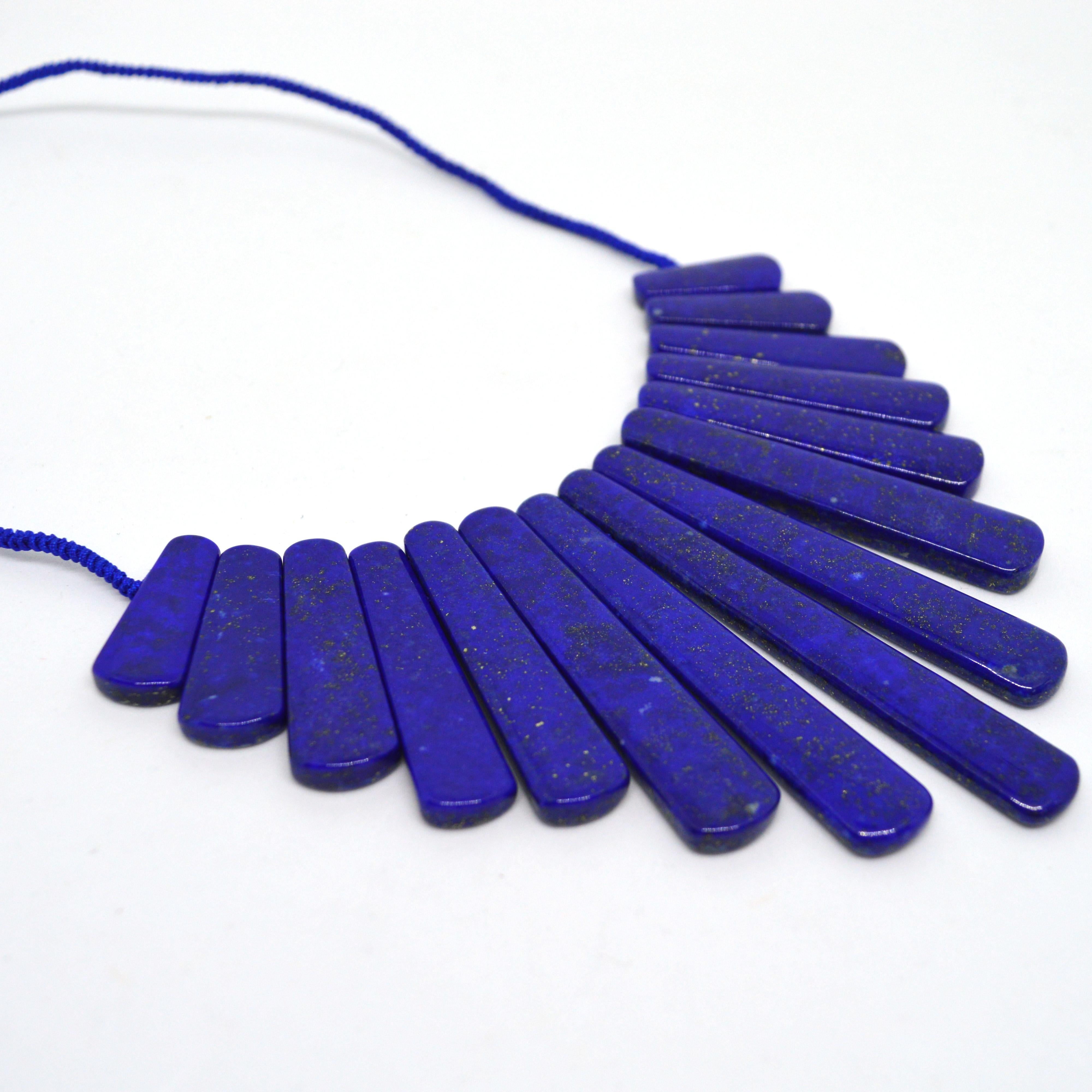 High Quality large natural Graduated Trapezoid Lapis Lazuli knotted necklace with a button Lapis Lazuli clasp. Beads Range from 25-80mm long  and the stones are 6mm thick .

Total necklace length 52mm.