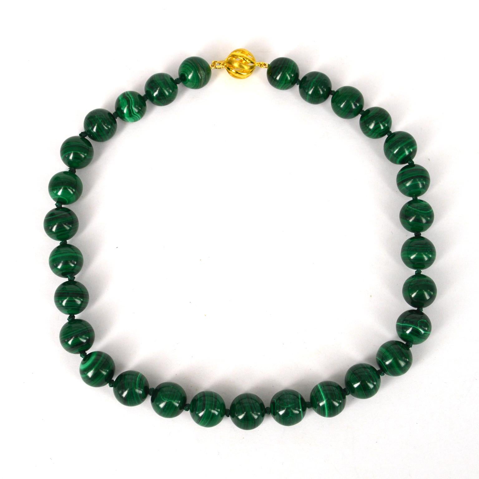 High Quality Natural 14mm Malachite beads hand knotted on matching thread with Gold Plate Sterling Silver 12mm clasp.
Total length of Necklace 47cm.

