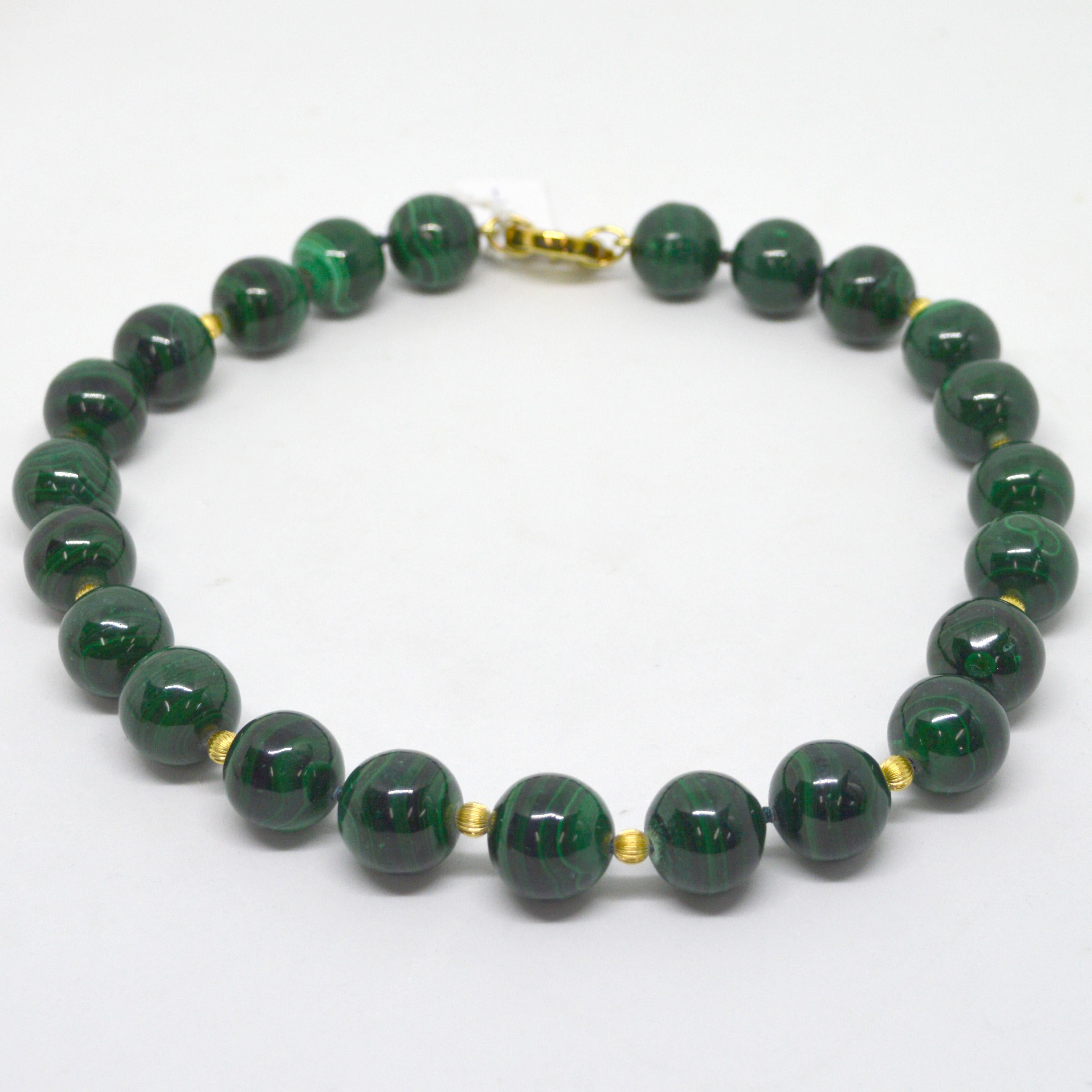 Large 18mm high polished round Malachite spheres with 5mm Corrugated 14k Gold filled beads and a 18mm Gold plate Sterling silver bolt clasp.
Necklace features 23 high polished 18mm natural Malachite beads

Malachite has banding of light and dark