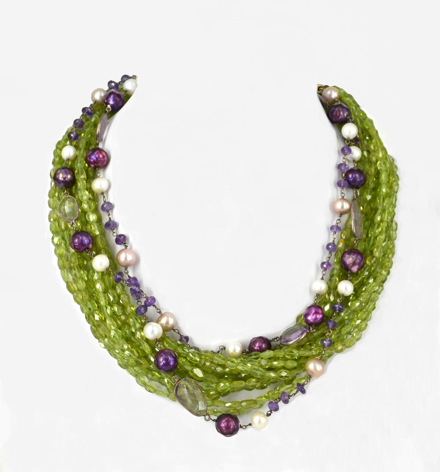 11 strands of faceted peridot 6x4mm beads with 2 strands of hand made link chain with Amethyst and Fresh Water Pearls finished with Gold plate Sterling Silver dome cap and 27mm hook clasp with a 10cm 14k Gold filled extension chain.
Total length of