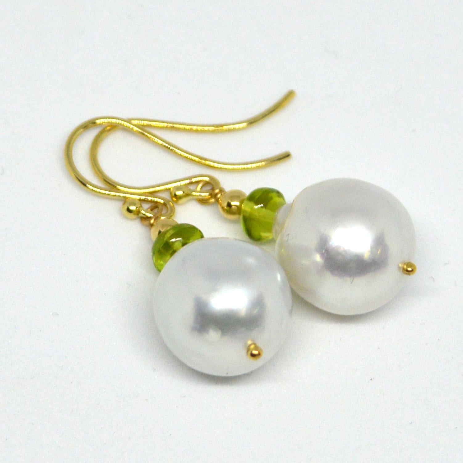 Natural Polished Peridot 5x3mm with 15x12.8mm high sheen South Sea Pearls set on 9ct yellow Gold Sheppard,  14k Gold head pin and 3mm round bead.

Total Earring length 36mm.