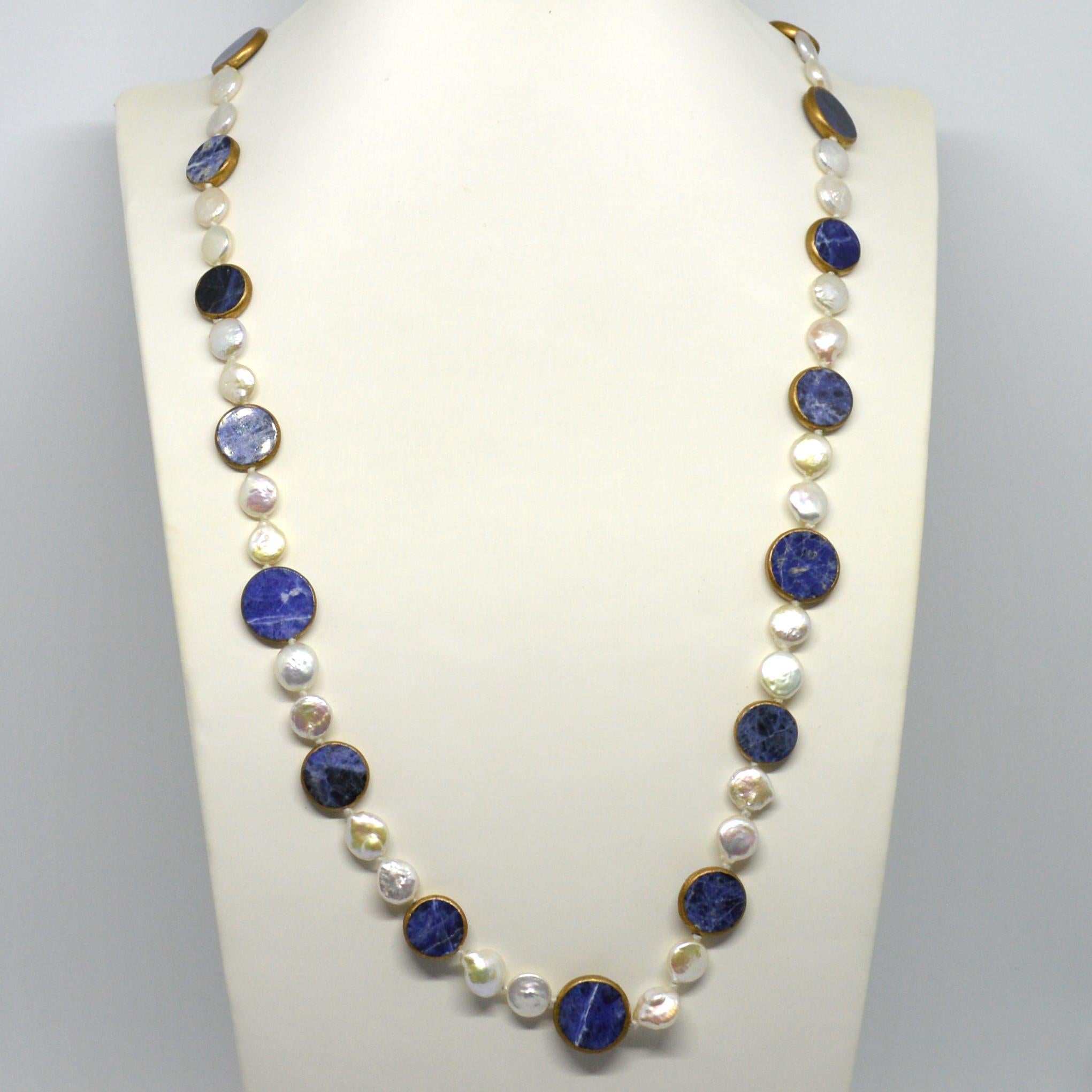  We have included a Pearl shortener so you can wear this Necklace doubled. 

 Description Fresh Water Pearl Coin 10x4mm
                     Sodalite approximatly 14mm and 18mm
                     Fresh Water Pearl and Sodalite is Bezel Set with