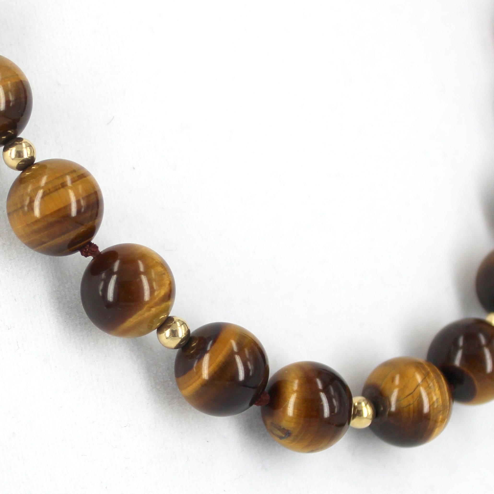 Tigers Eye 14mm Polished Round Bead Necklace 52cm Knotted in Sections

Descriptions Tigers Eye Round Beads 14mm 
                      Gold Filled Round Beads 5mm 
                      