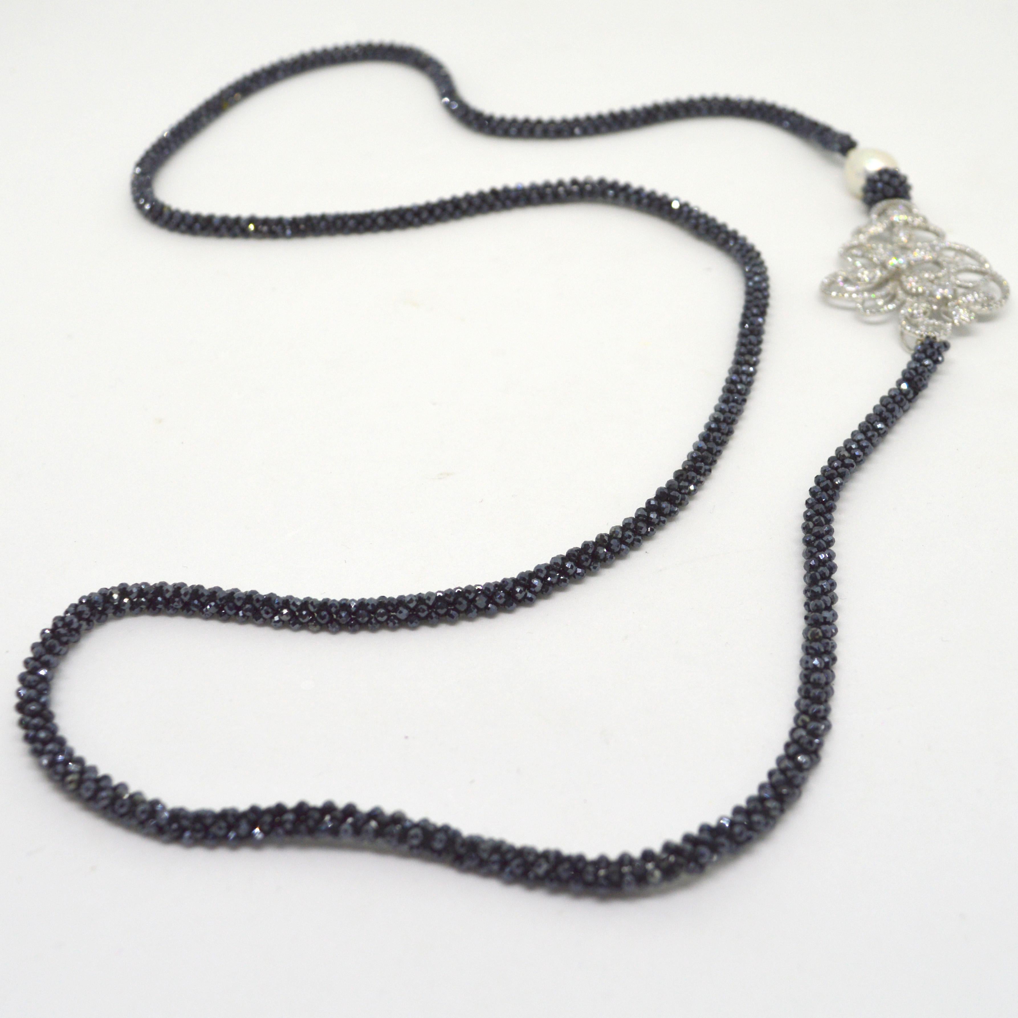 Stunning strand of woven 2mm micro faceted Black Spinel beads, Highlighted by a 16mm Baroque Fresh Water Pearl and a large Mirco Pave Cubic Rhodium plate connector. 
length 74cm  or 29inches