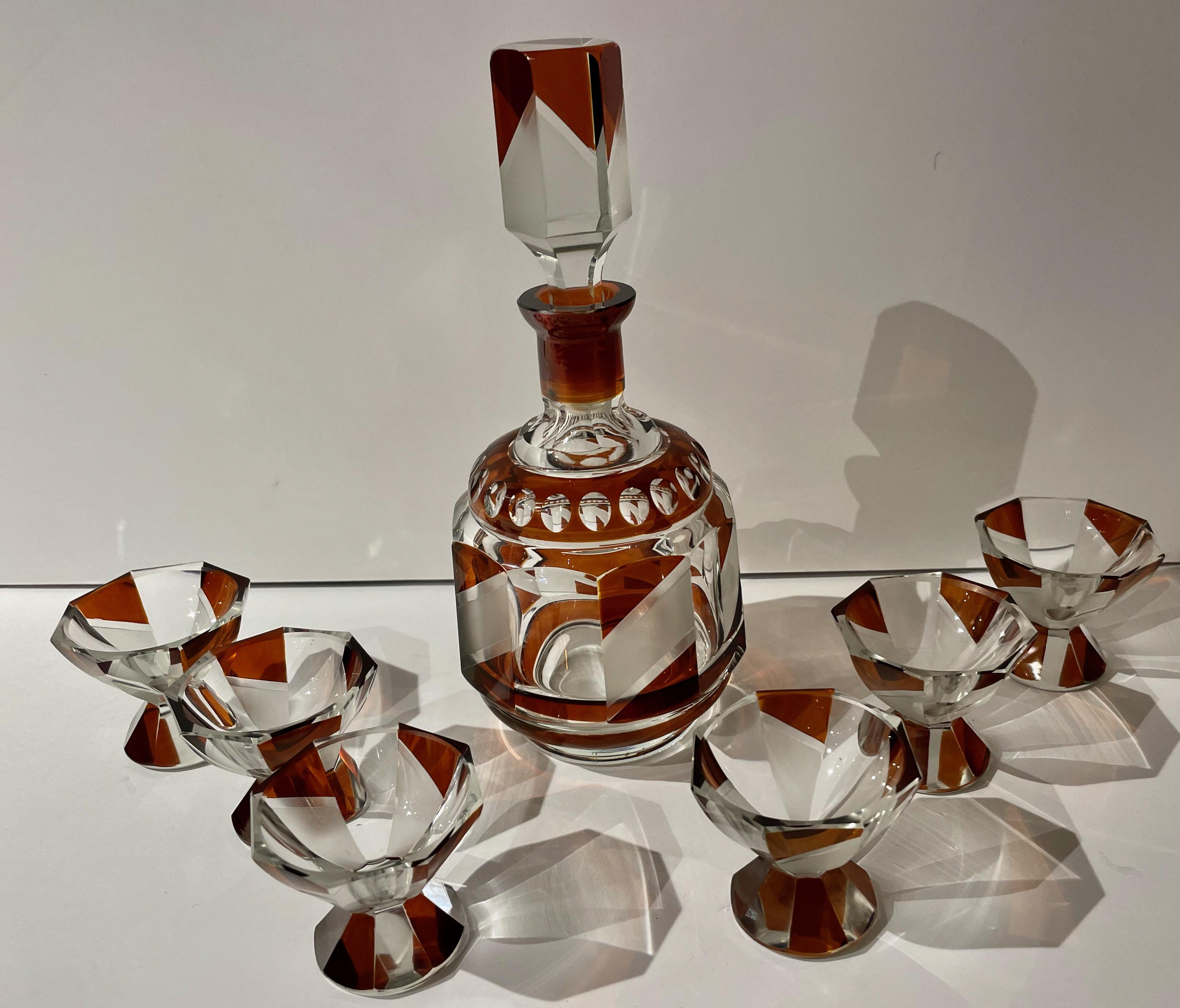 Decanter and glasses Modernist by Karl Palda with Rootbeer-Burgandy Color. An original Art Deco Decanter Set by Karl Palda, the master of Czechoslovakian glass design. This decanter is a bit unusual: It has a natural pouring spout and is capped with